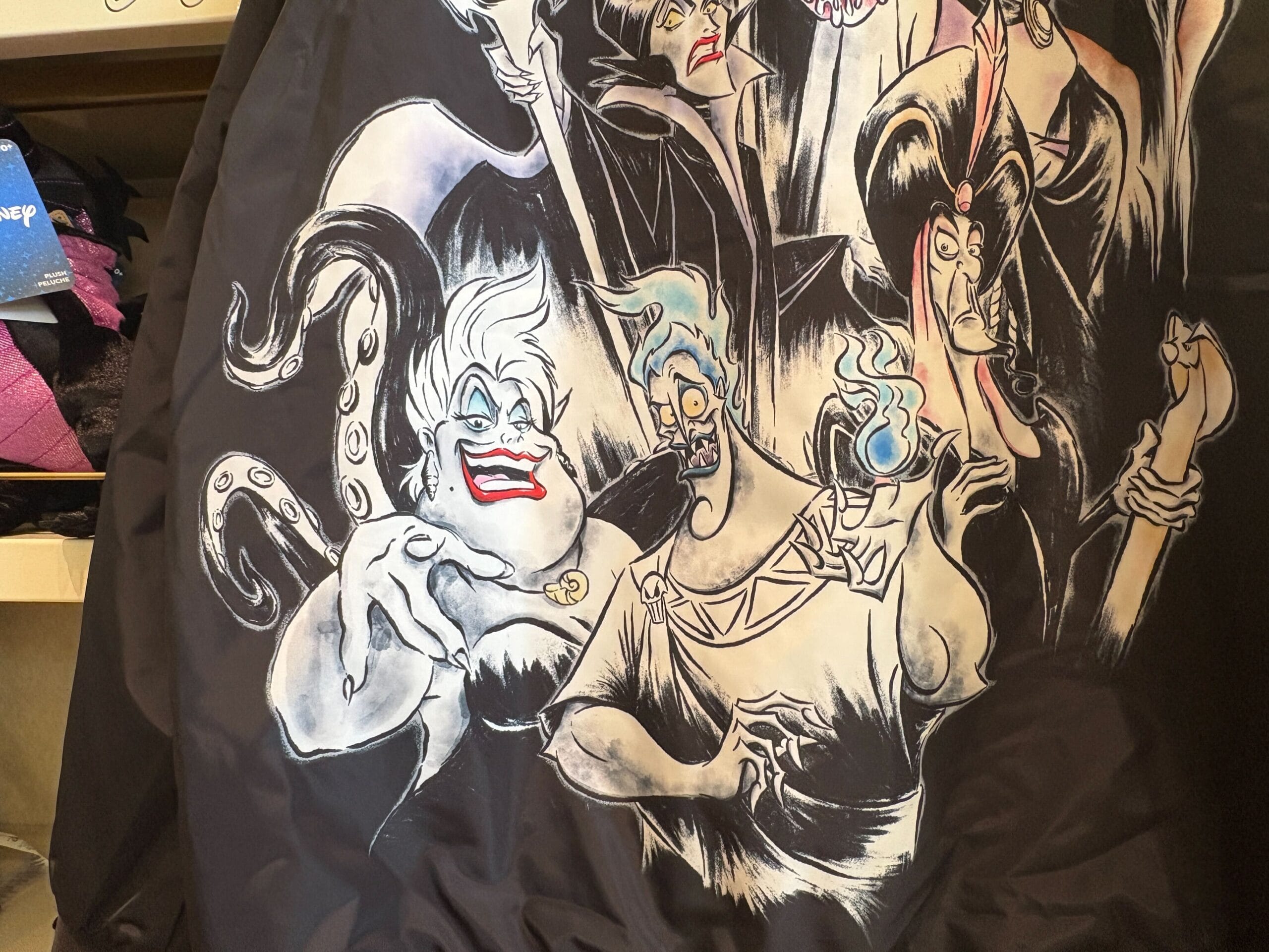 Illustration of Disney villains Ursula, Hades, Maleficent, and Cruella de Vil on a black jacket.