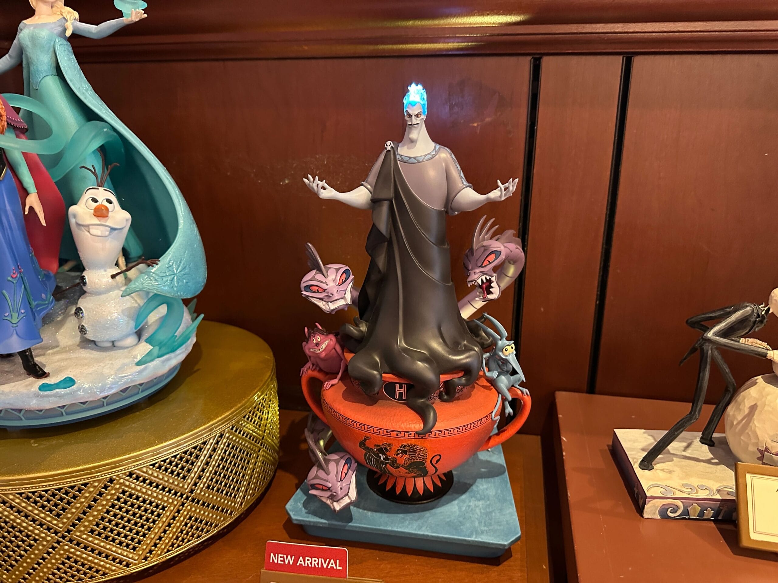 A Hades figurine from Disney’s Hercules with flaming hair and purple creatures, perfect for Disney Villains merchandise.