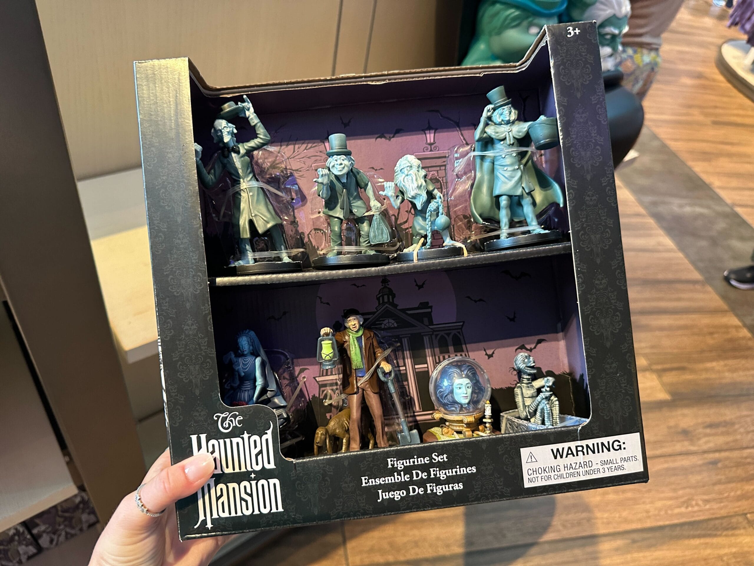 Boxed Haunted Mansion figurine set with six ghostly characters, including a head in a crystal ball.