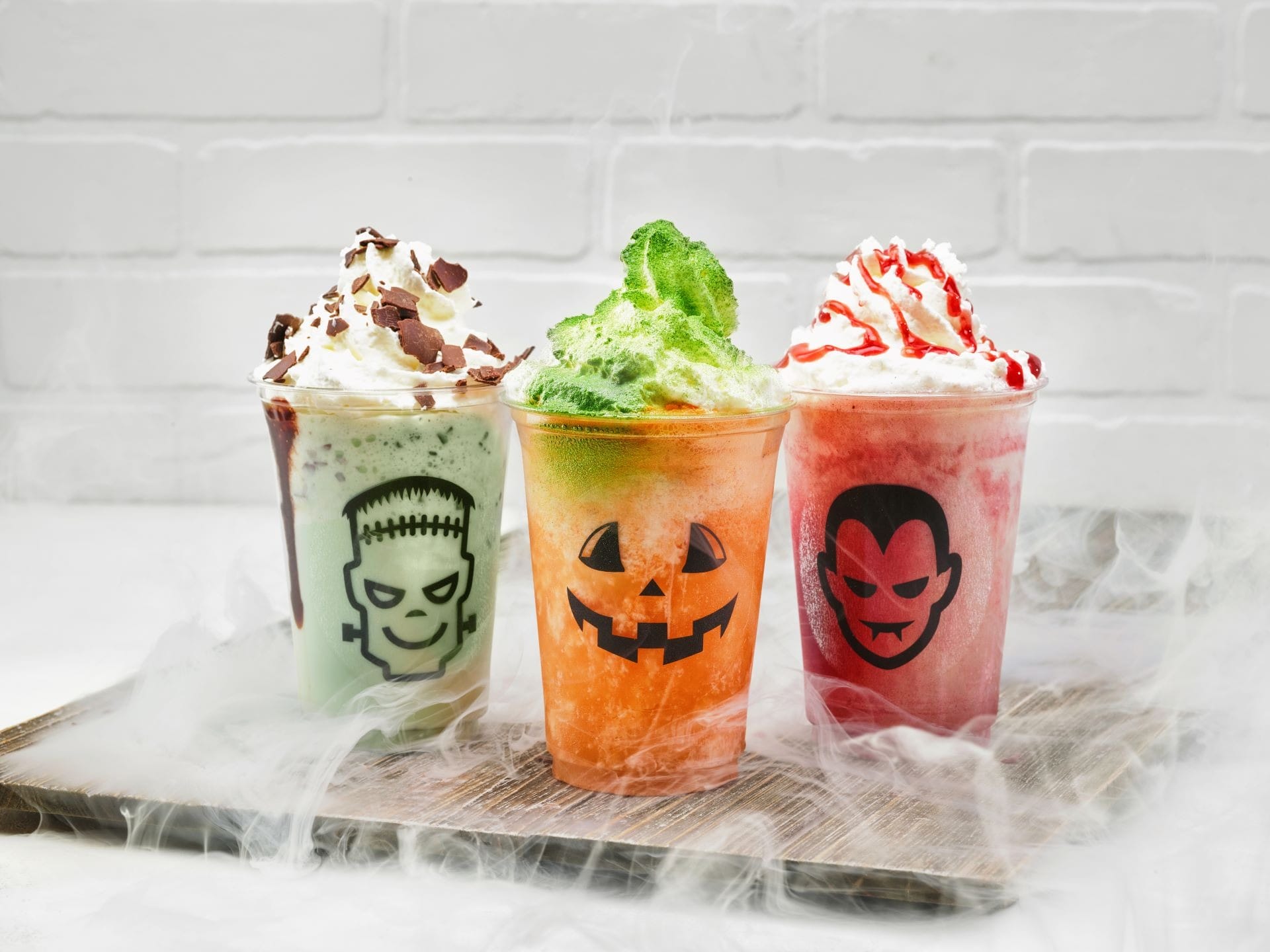Three 2025 Halloween Treats: festive drinks with whipped cream, each topped with a spooky Walt Disney World character face.