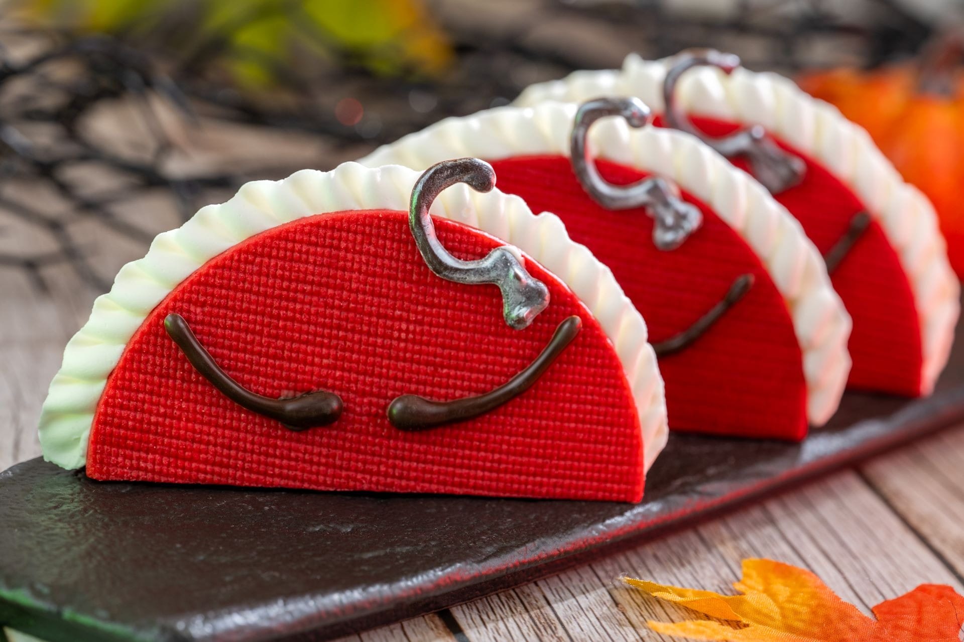 Three red and white taco-shaped desserts with closed eyes, perfect 2025 Halloween Treats at Walt Disney World.