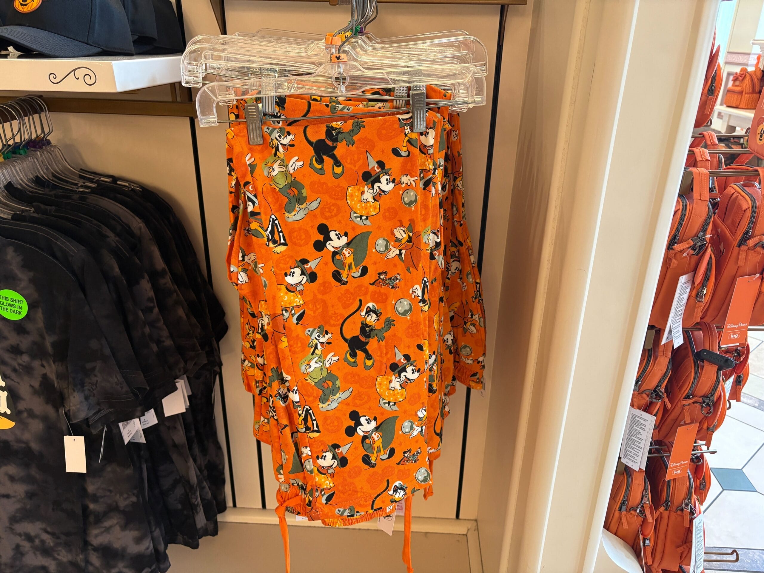 Bright orange skirt featuring Disney Halloween Merch with classic cartoon characters, displayed in a retail store for 2025.