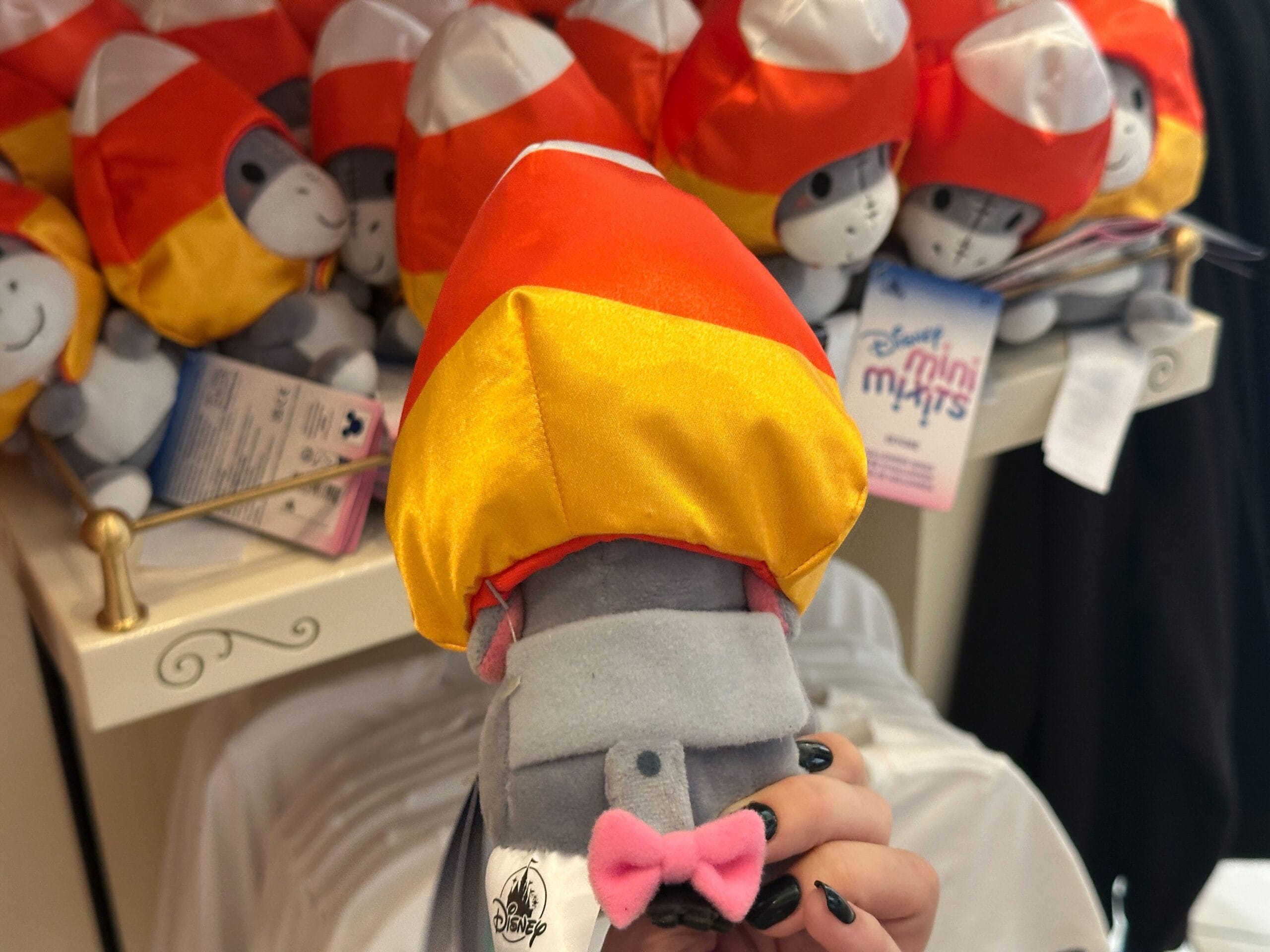 A plush stuffed hippo in a rocket hat, part of the 2025 Disney Halloween Merch at Walt Disney World store shelves.