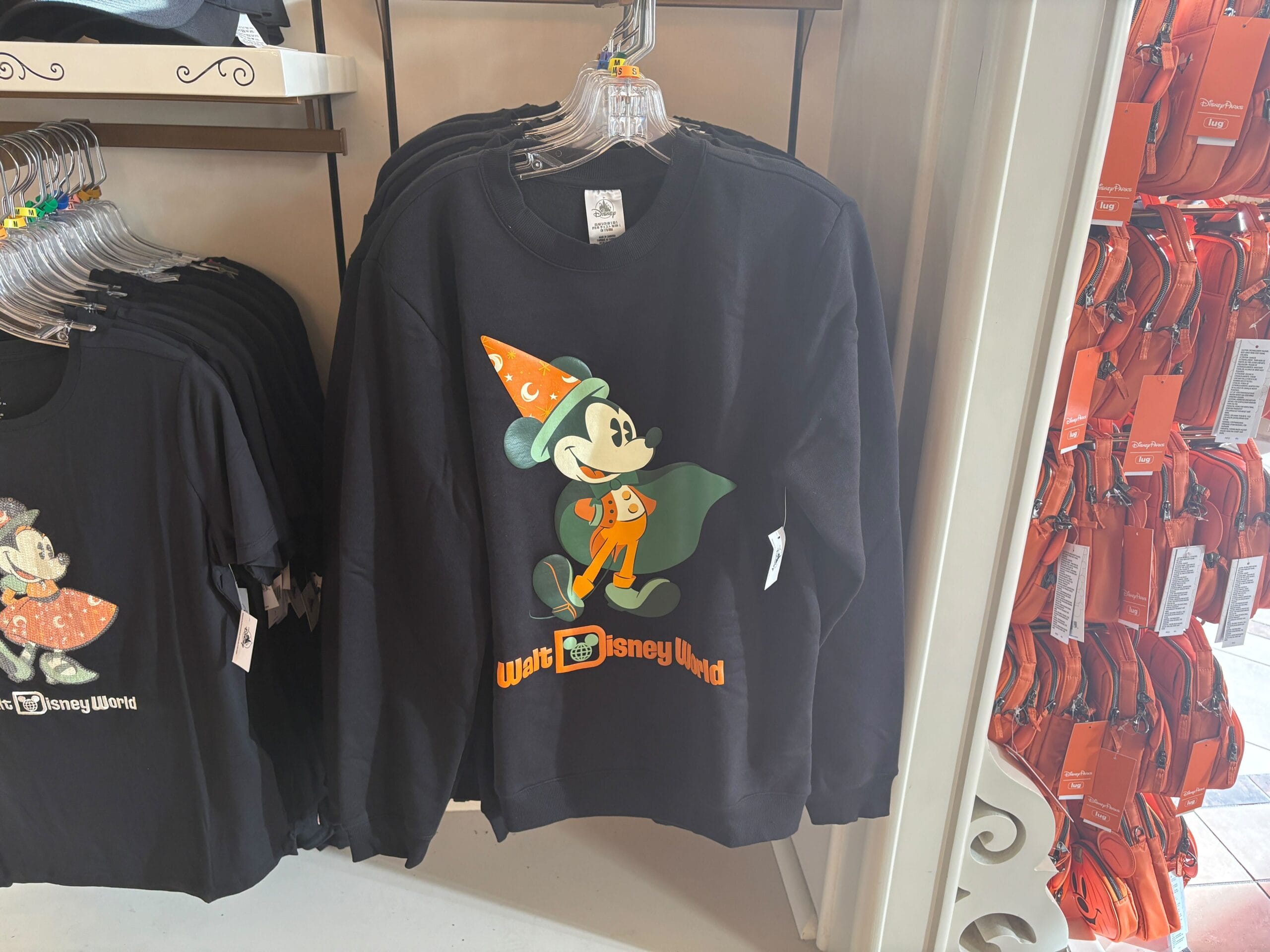 Disney Halloween Merch 2025 - Black sweatshirt with Mickey Mouse in a wizard hat and cape—perfect Halloween merchandise from Walt Disney World.
