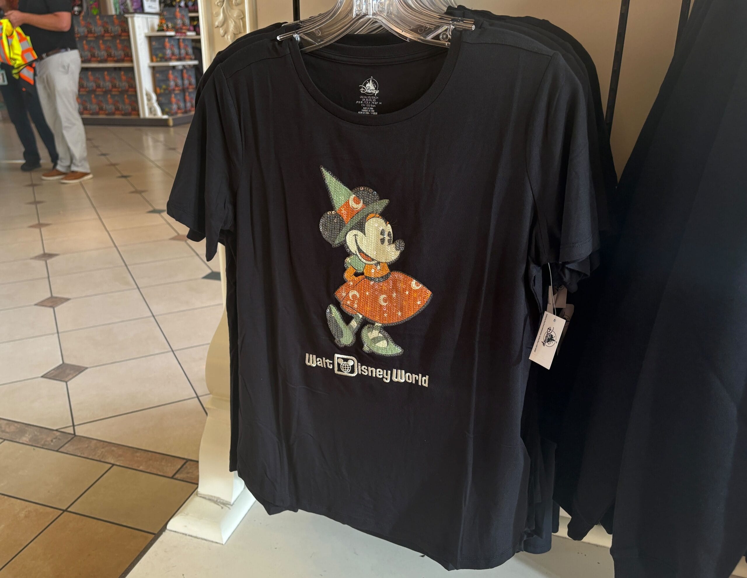 Disney Halloween Merch 2025 - Black t-shirt featuring Minnie Mouse in a witch costume—perfect Halloween merchandise from Walt Disney World.