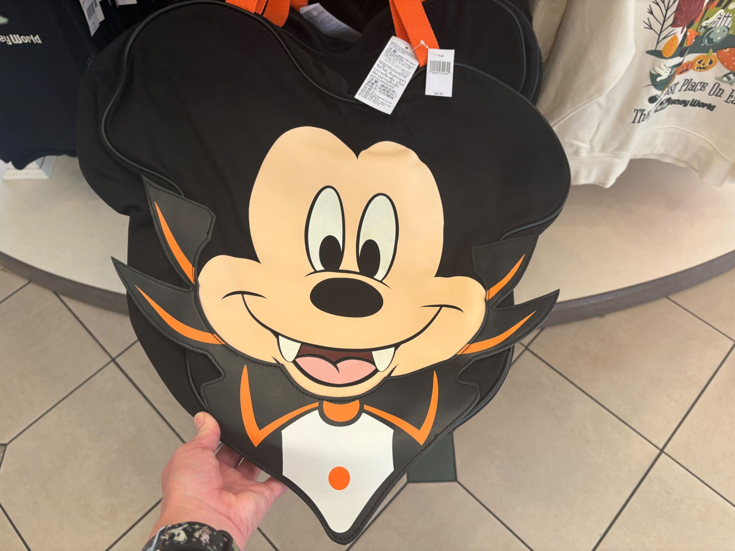 Person holding a large Mickey Mouse vampire bag—an exclusive piece of Halloween Merchandise at Walt Disney World.