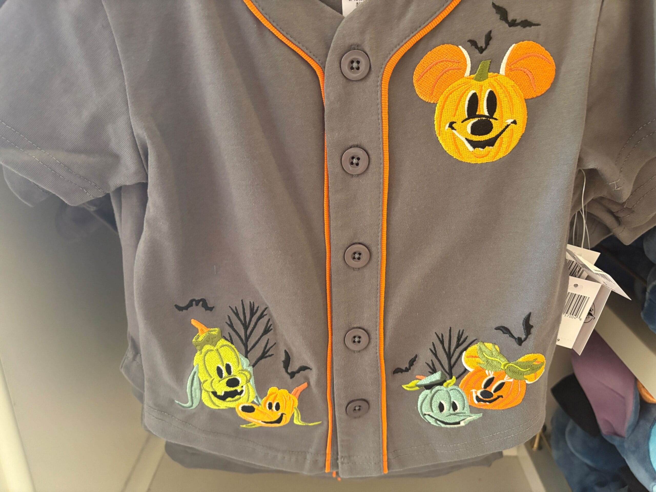 Gray shirt with orange trim, part of Walt Disney World Halloween merchandise, features pumpkin and bat Disney characters.