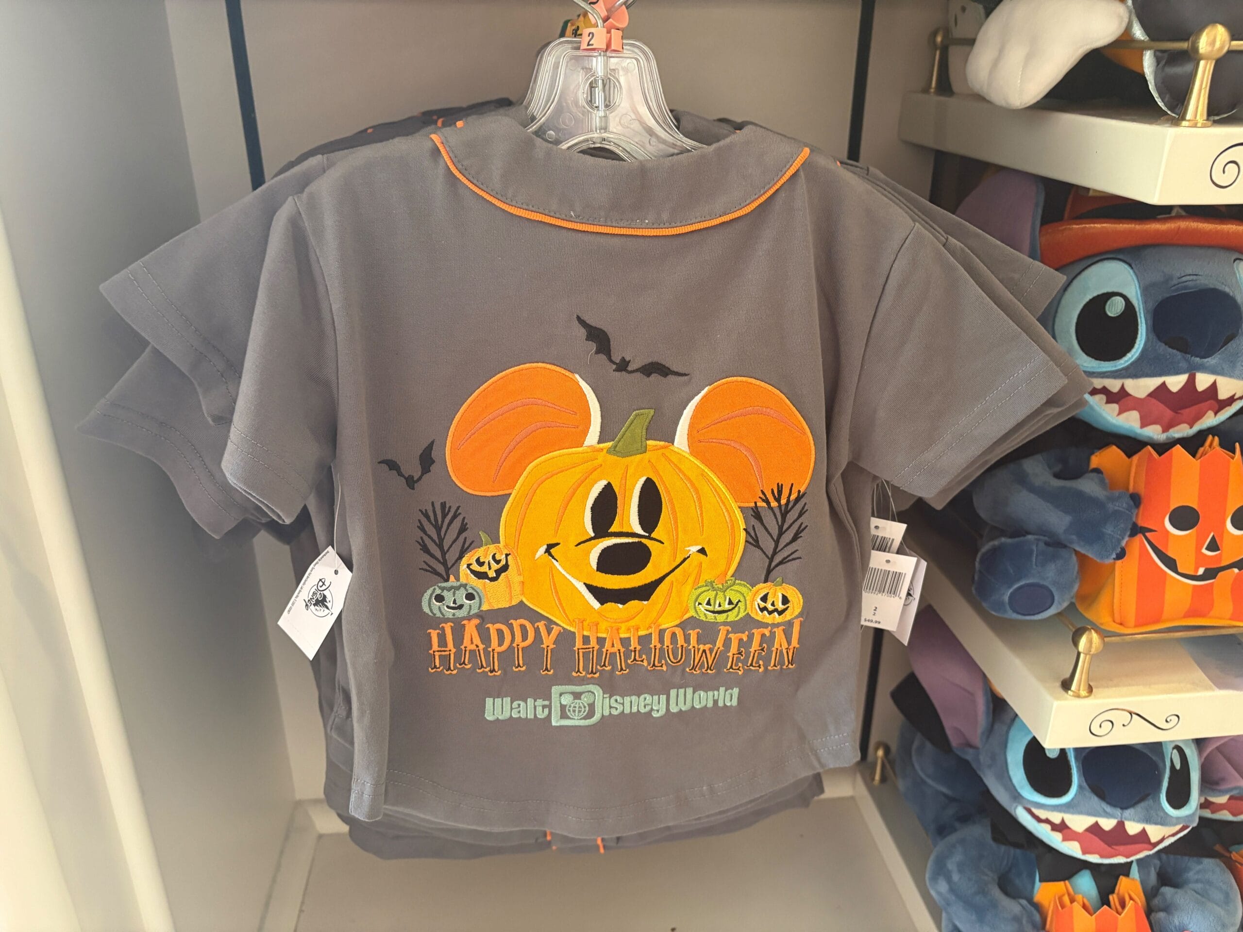 Gray Halloween shirt featuring Mickey Mouse as a pumpkin and bats—a must-have piece of Walt Disney World Halloween merchandise.