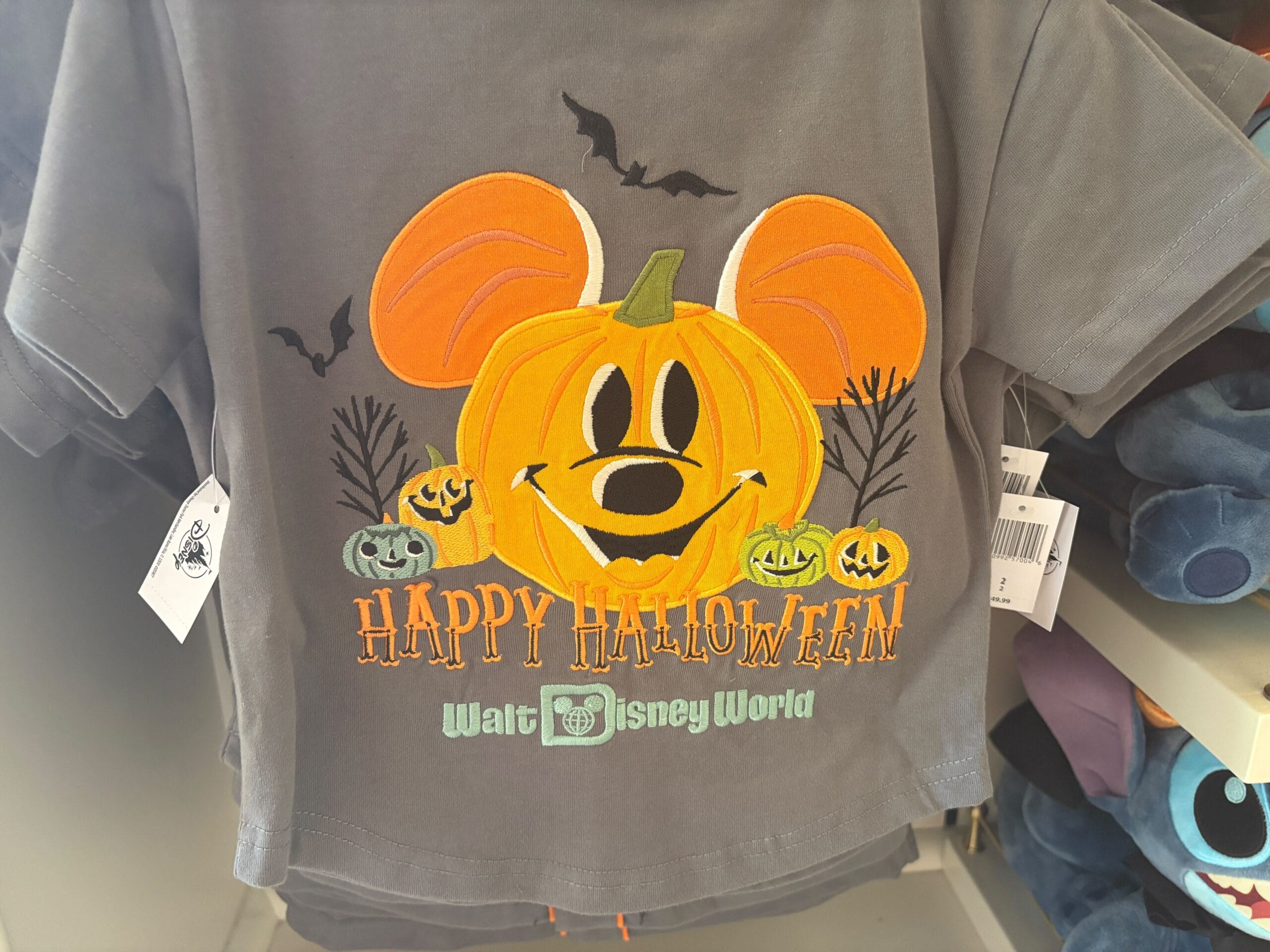 Gray t-shirt with a Mickey Mouse pumpkin, bats, and "Happy Halloween Walt Disney World"—spooky Halloween merchandise.