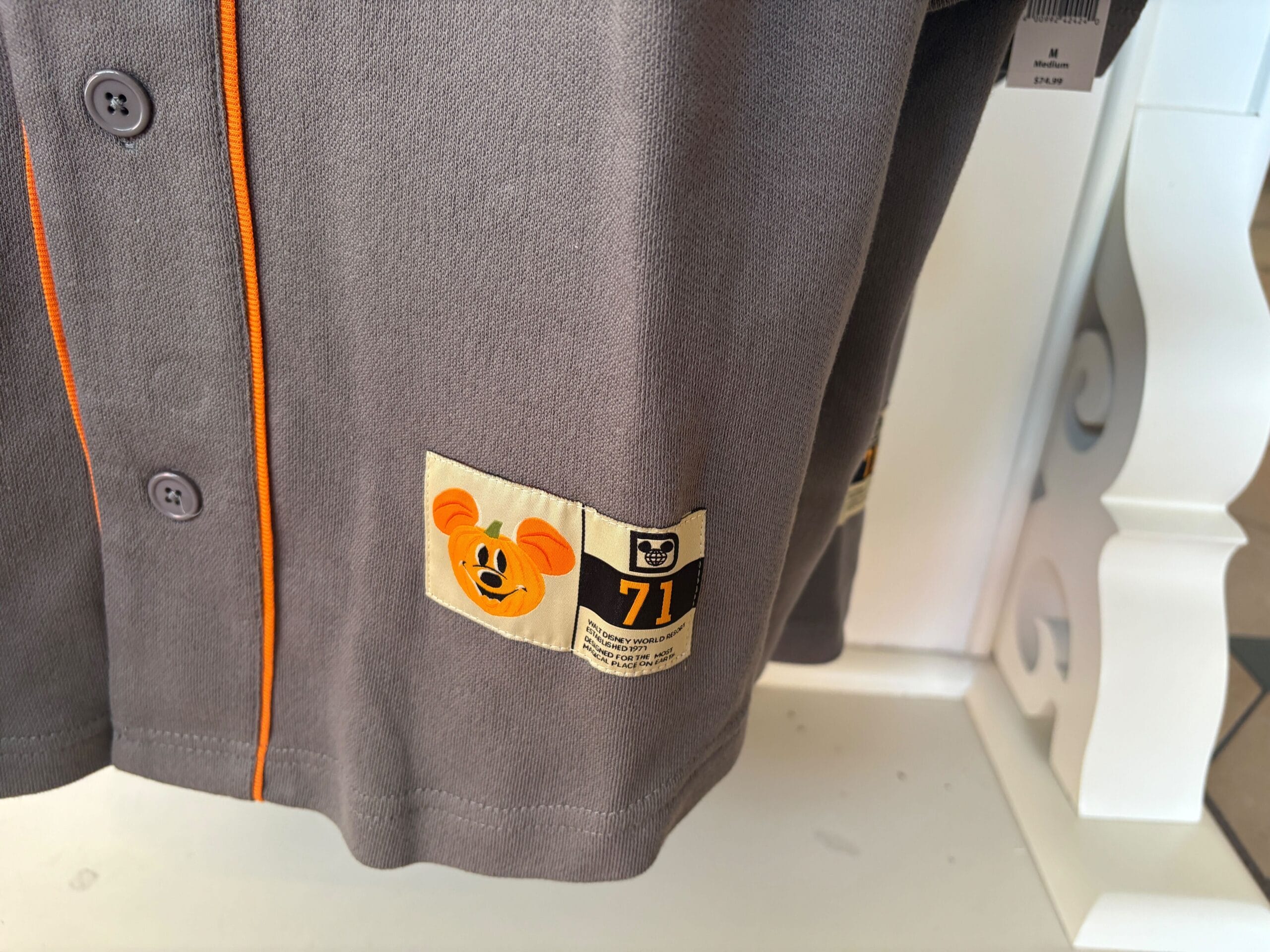 Gray shirt with orange trim, Mickey patch, and yellow "71" near the hem—perfect Walt Disney World Halloween merchandise.