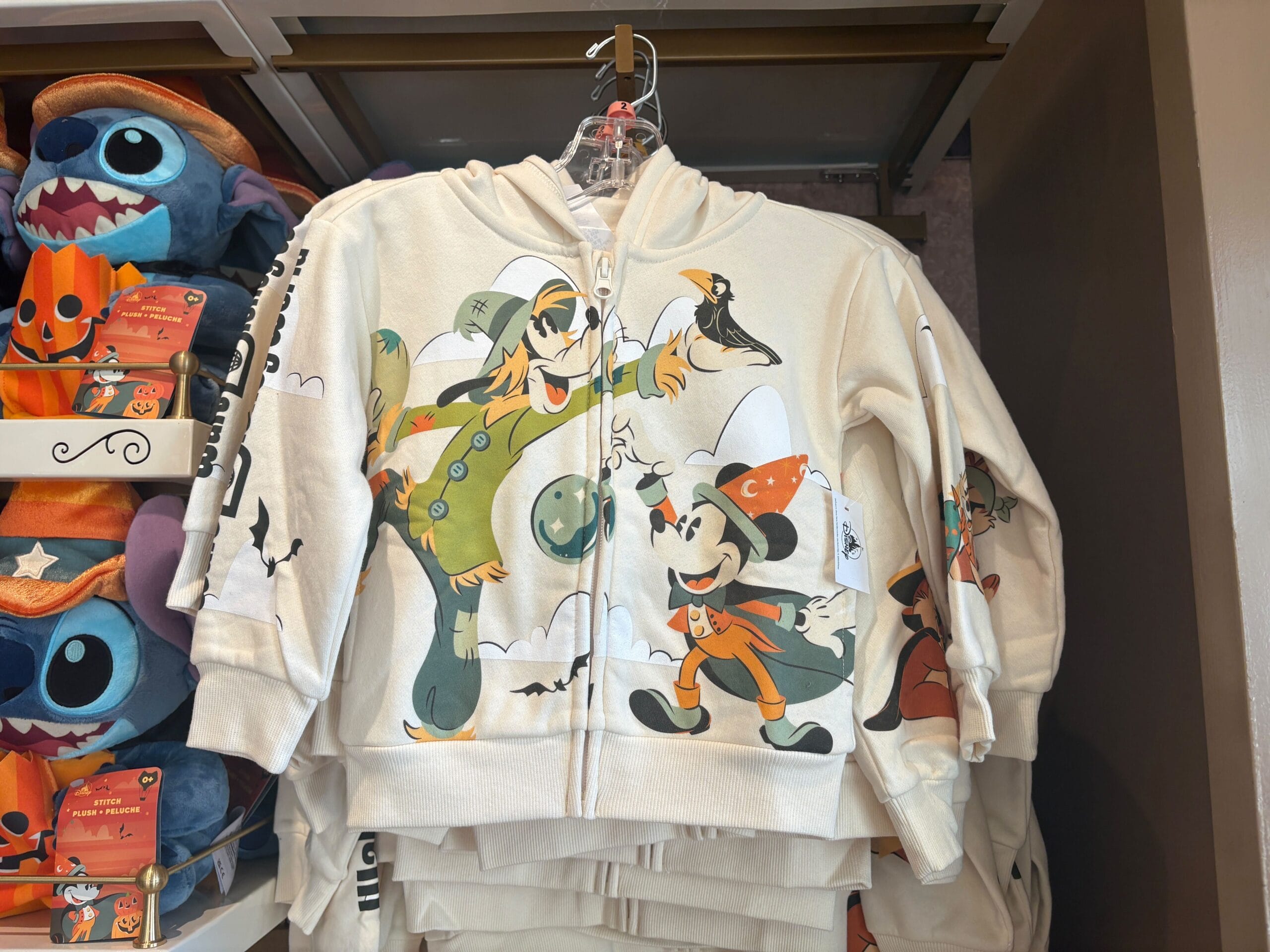 Disney Halloween Merch 2025 - Cream hoodie featuring Halloween-themed Goofy and Mickey Mouse, part of Walt Disney World Halloween merchandise by Stitch plush toys.