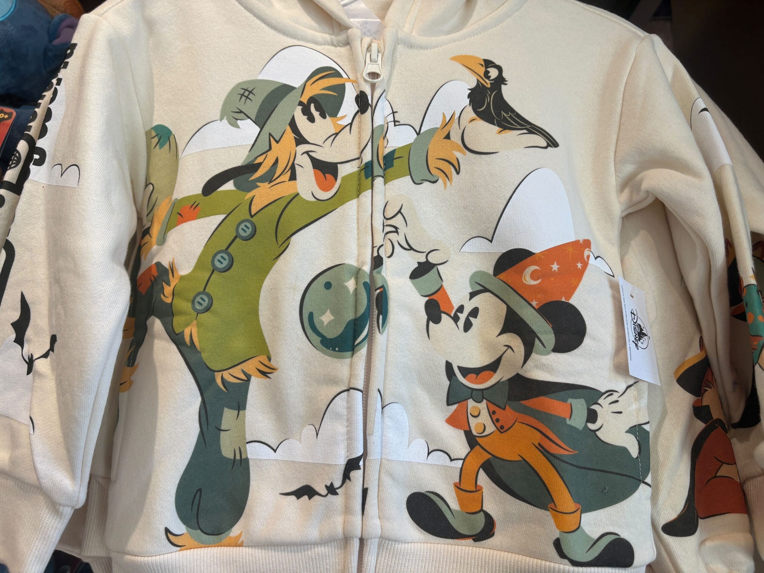 Halloween merchandise hoodie featuring a cartoon scarecrow, mouse, bats, and clouds—perfect for Walt Disney World fans.
