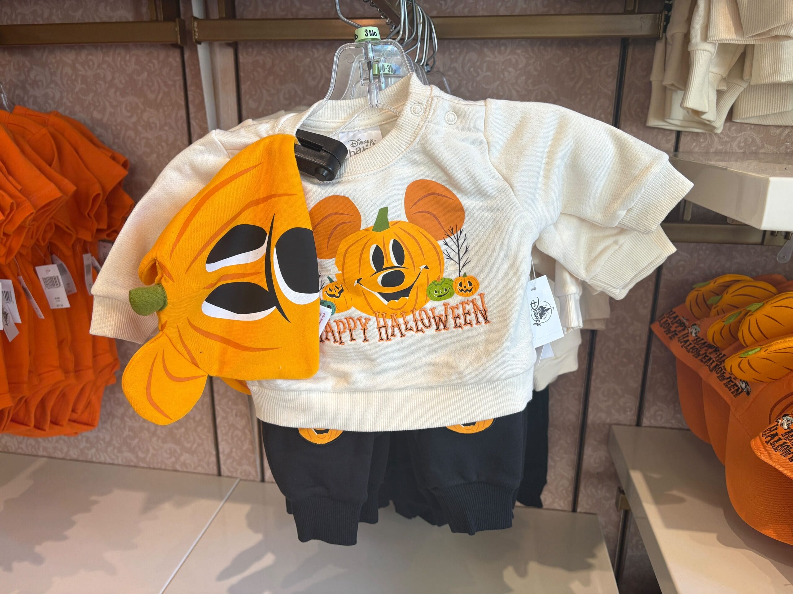 A Halloween Merchandise outfit: pumpkin hat and Disney "Happy Halloween" sweatshirt from Walt Disney World.