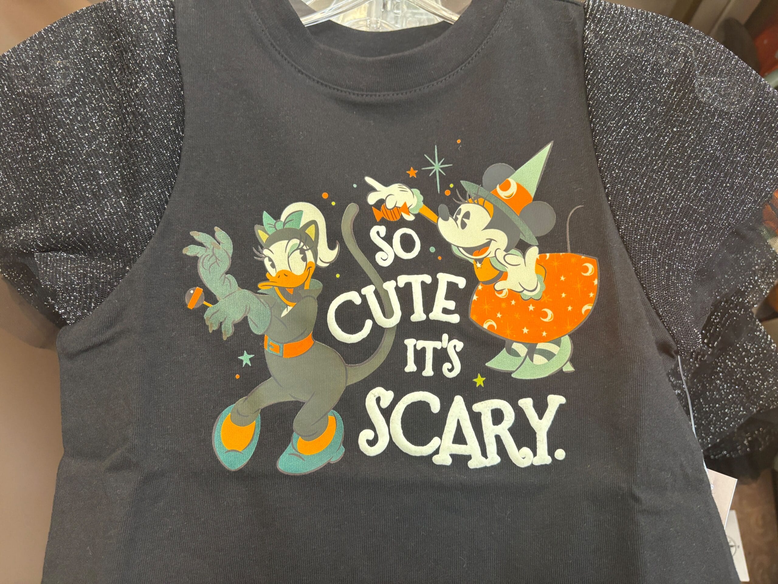 Black shirt from Walt Disney World: Minnie as a witch, Daisy as a cat. "So cute it's scary." Halloween merchandise.