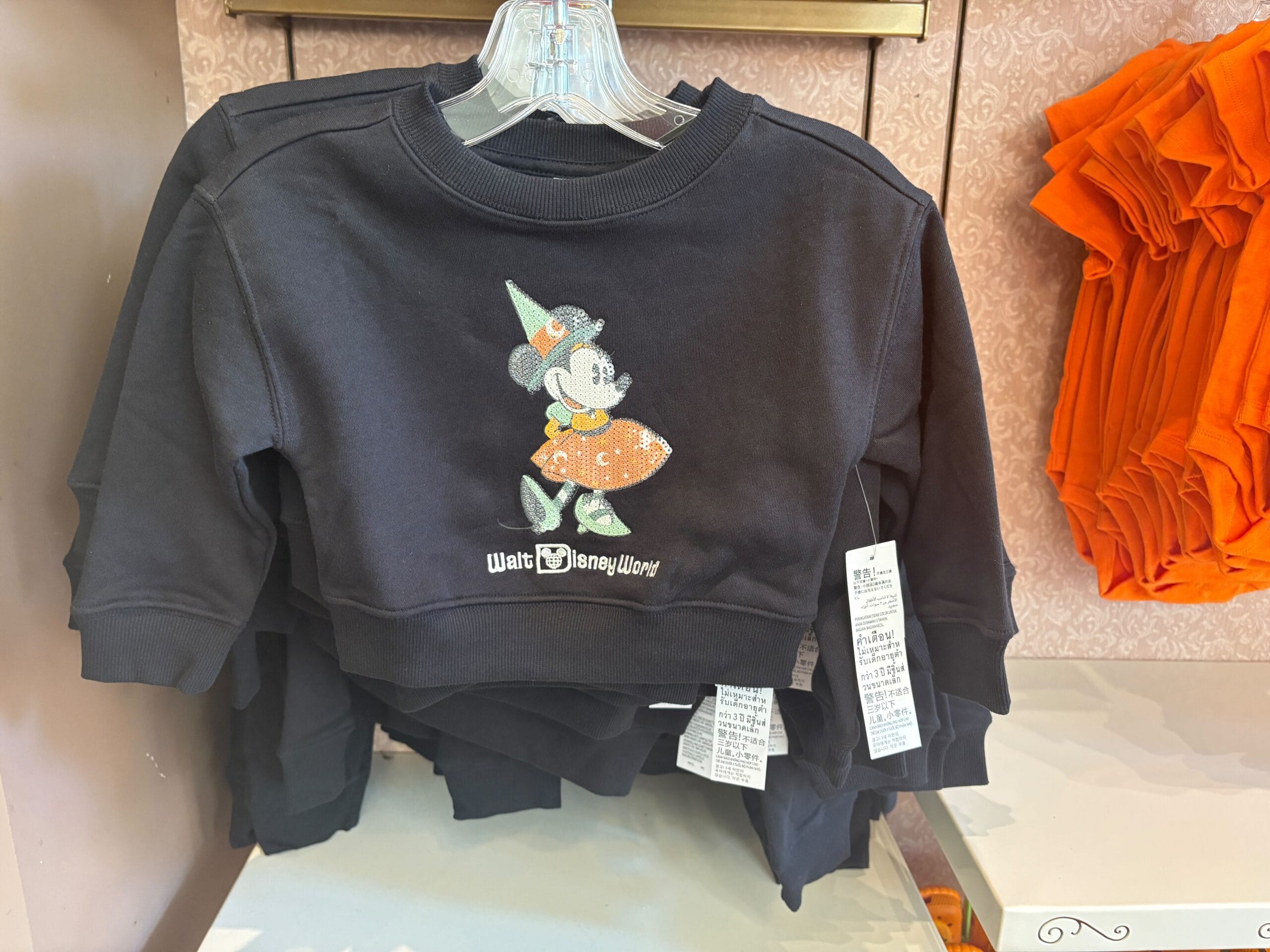 Black toddler sweatshirt featuring Minnie Mouse in a Halloween costume—perfect Walt Disney World Halloween merchandise.