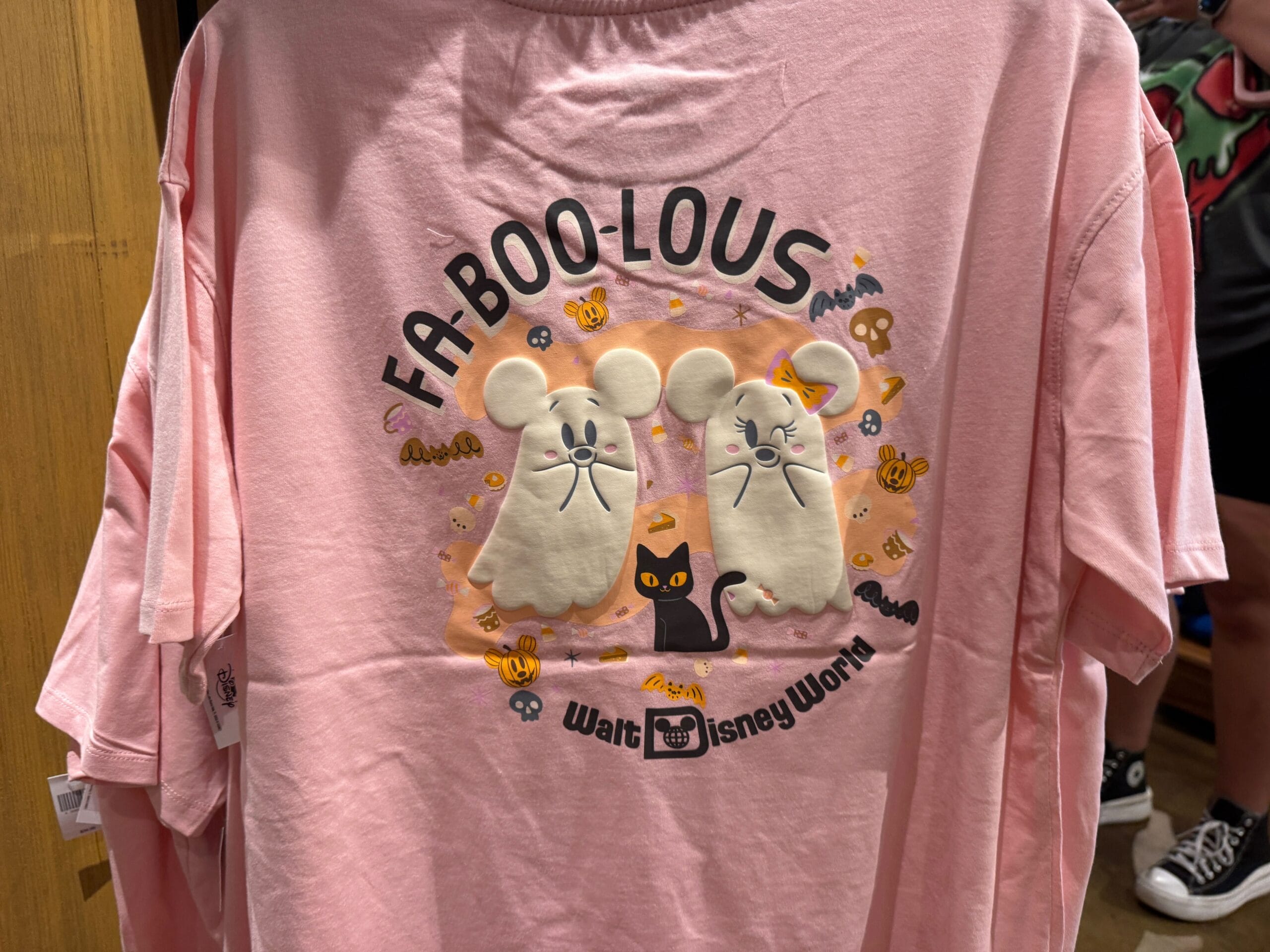 Pink shirt with ghost mice, a black cat, and “Fa-BOO-lous” Halloween merchandise from Walt Disney World.