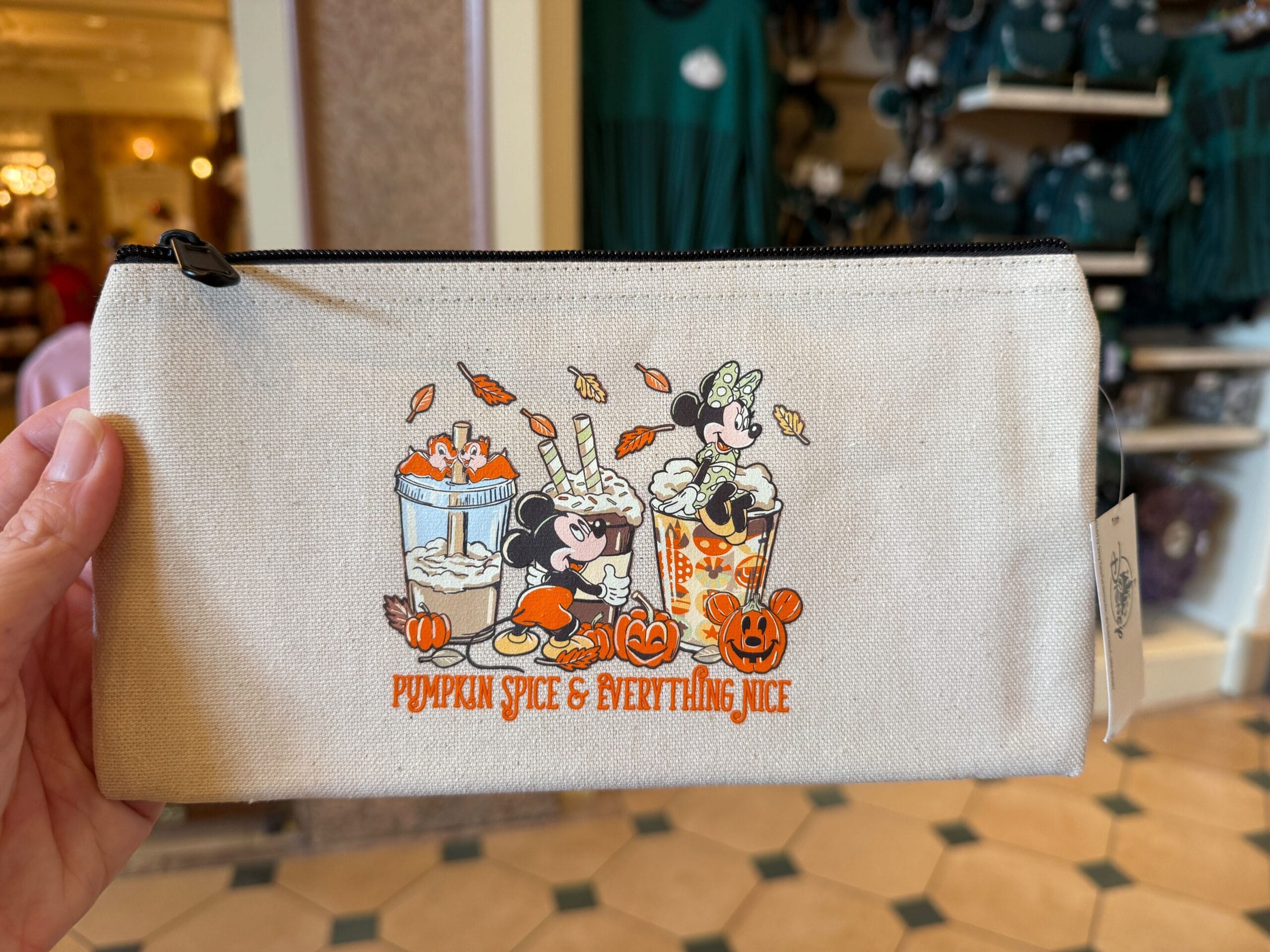 Beige pouch with Mickey and Minnie enjoying pumpkin spice drinks, part of the 2025 Disney Halloween Merch at Walt Disney World.