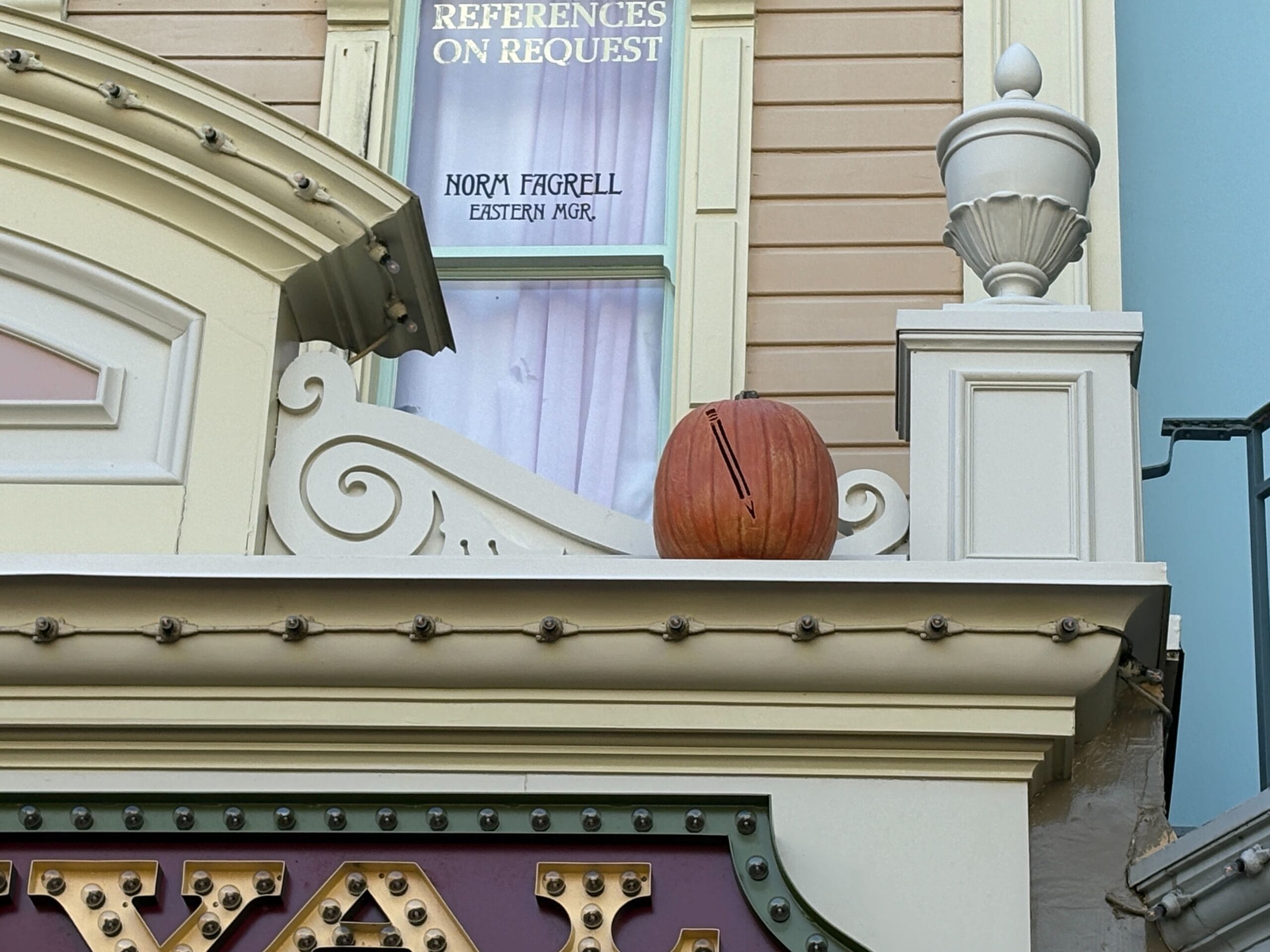 A Jack-o'-Lantern sits on a decorative ledge beneath a window with a sign reading "REFERENCES ON REQUEST.