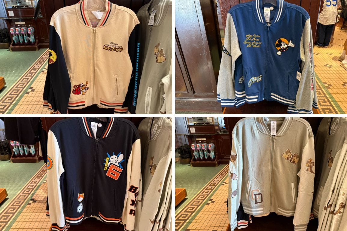 Four Character Varsity Jackets with embroidered Disney icons hang on display racks at Disneyland.