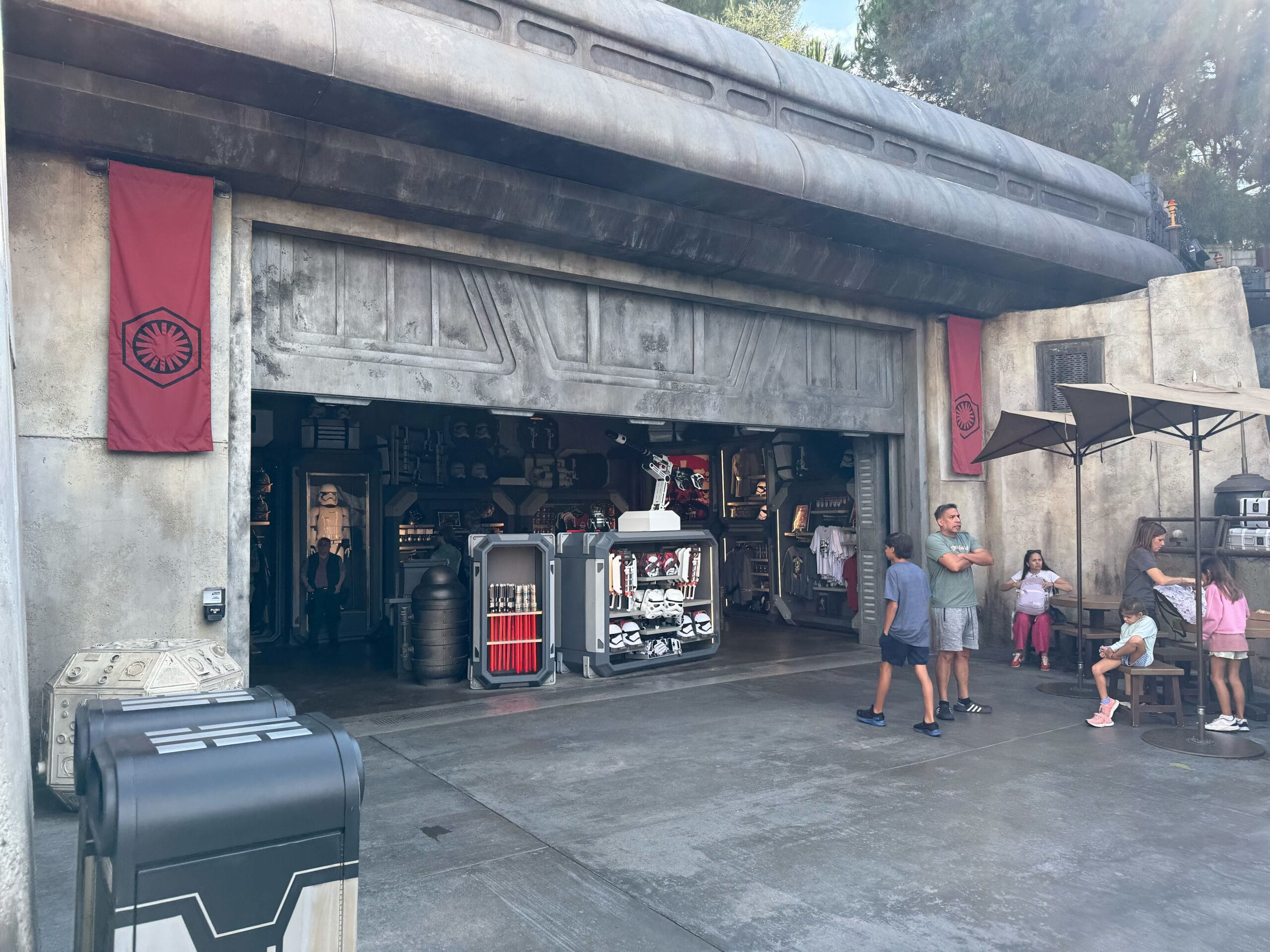 A Star Wars-themed shop at Disneyland with First Order banners and Star Wars shirts displayed at the entrance.