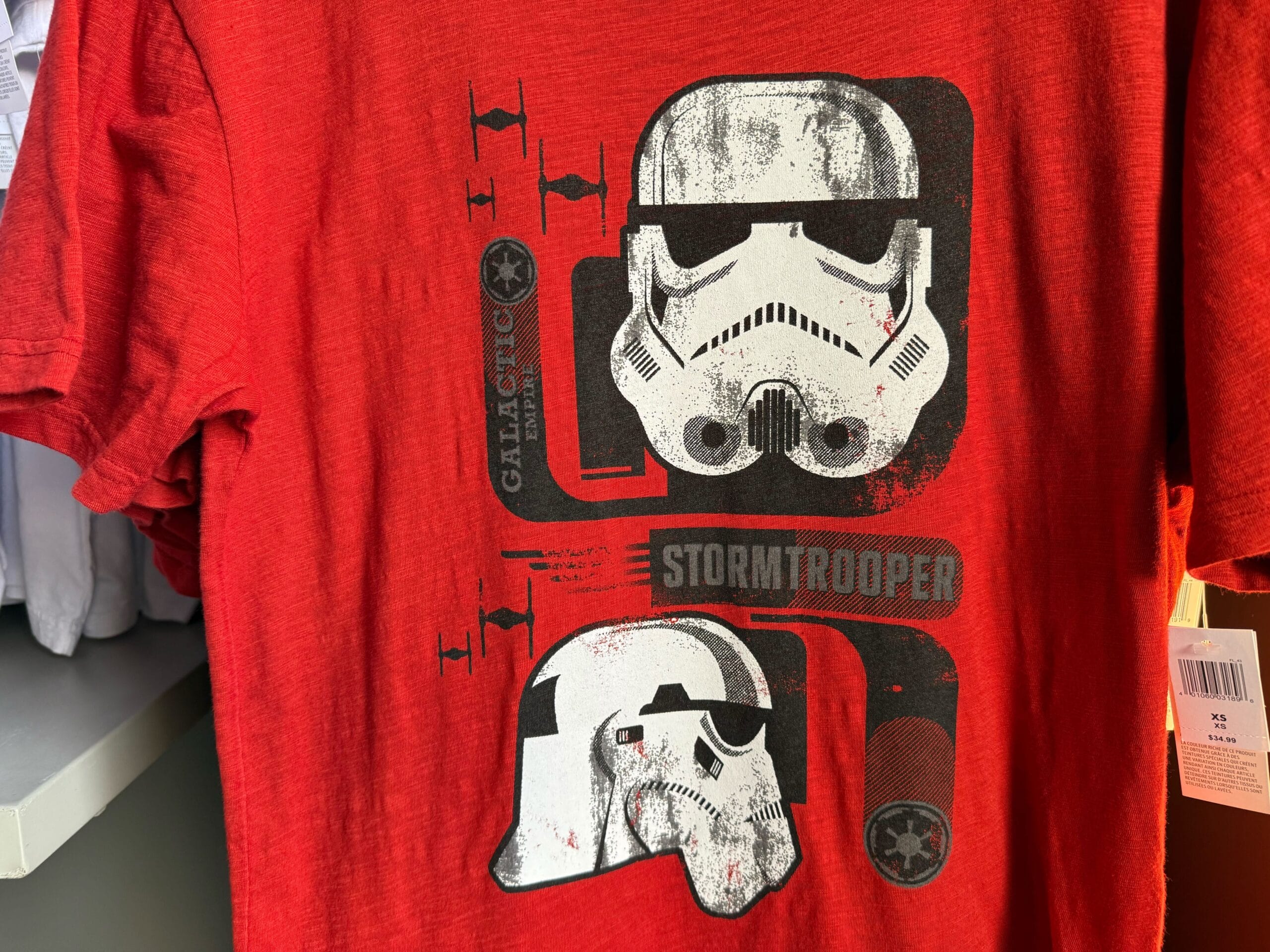 Red Star Wars shirt featuring two white Stormtrooper helmets and "Galactic" and "Stormtrooper" text—perfect for Disneyland trips.