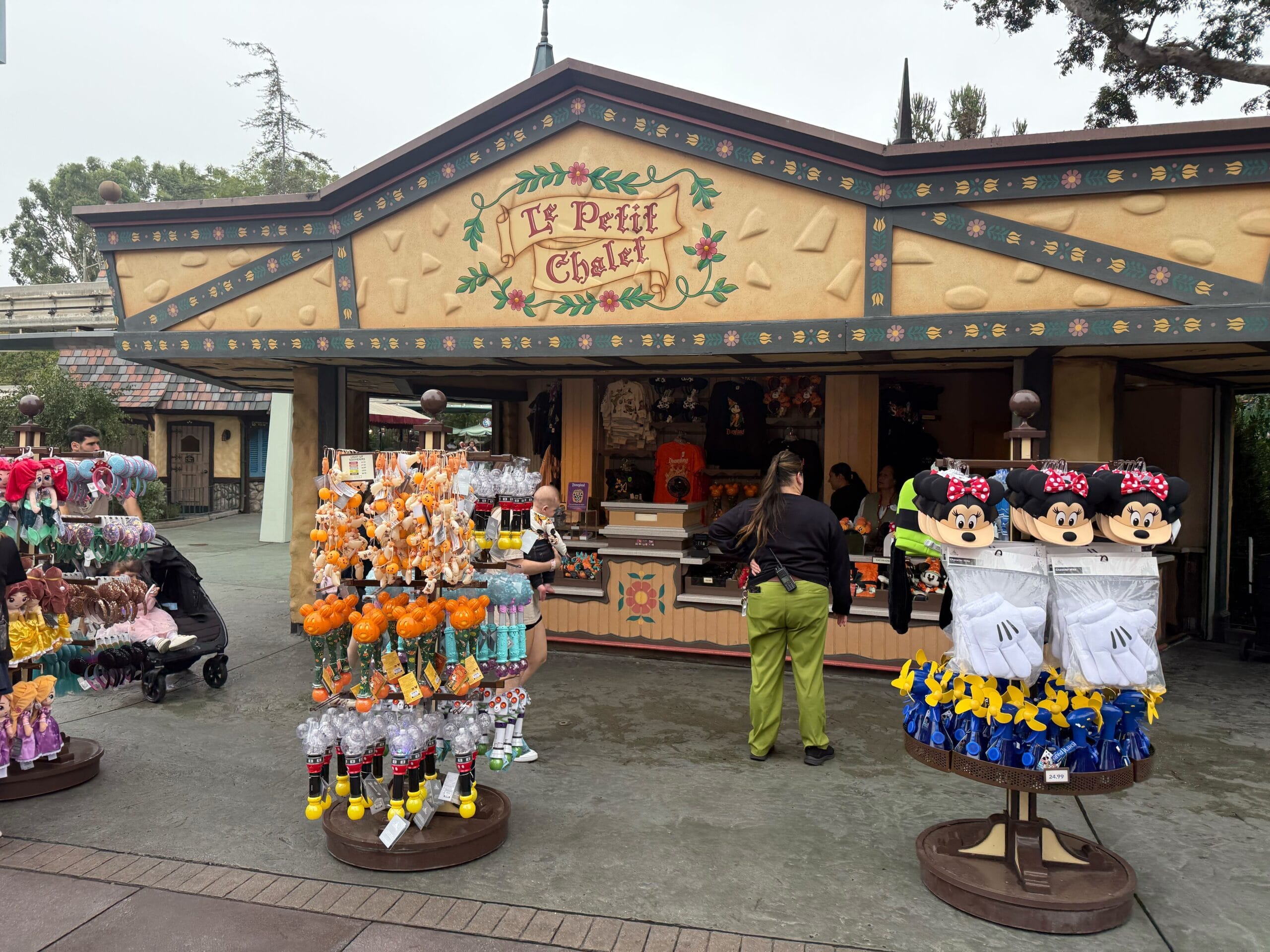 Le Petit Chalet outdoor shop offers Disneyland souvenirs and 70th Anniversary Mickey Mouse Club merchandise for shoppers.