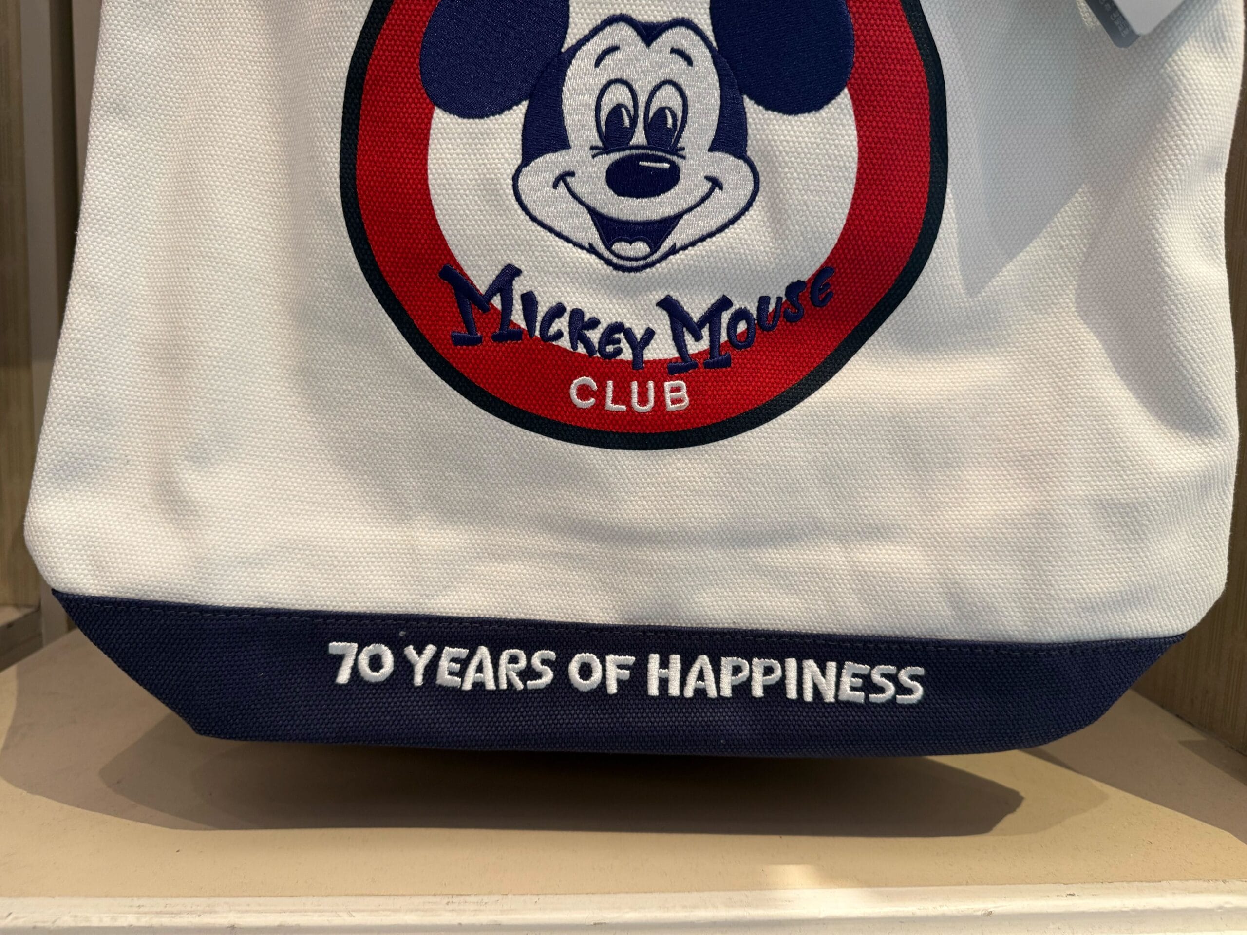 A bag featuring the Mickey Mouse Club logo and "70 Years of Happiness"—perfect Disneyland 70th anniversary merchandise.