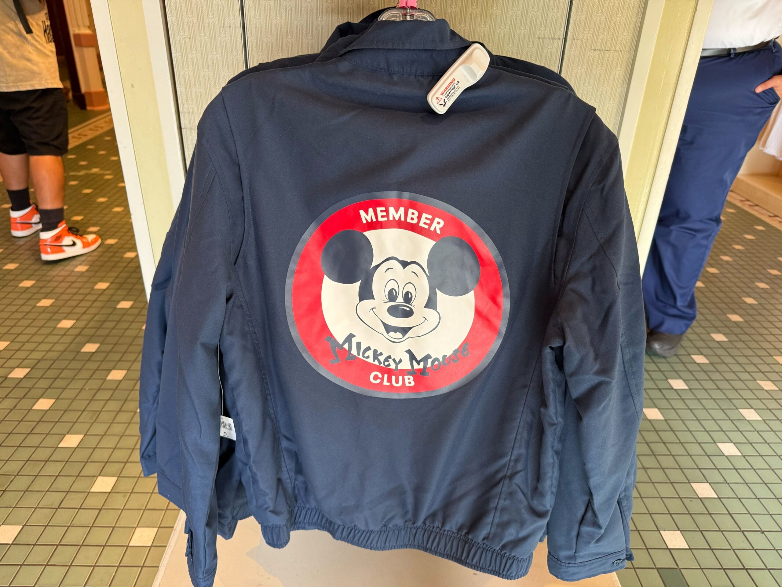 Navy jacket with a large "Mickey Mouse Club Member" logo—perfect 70th anniversary Mickey Mouse Club merchandise.