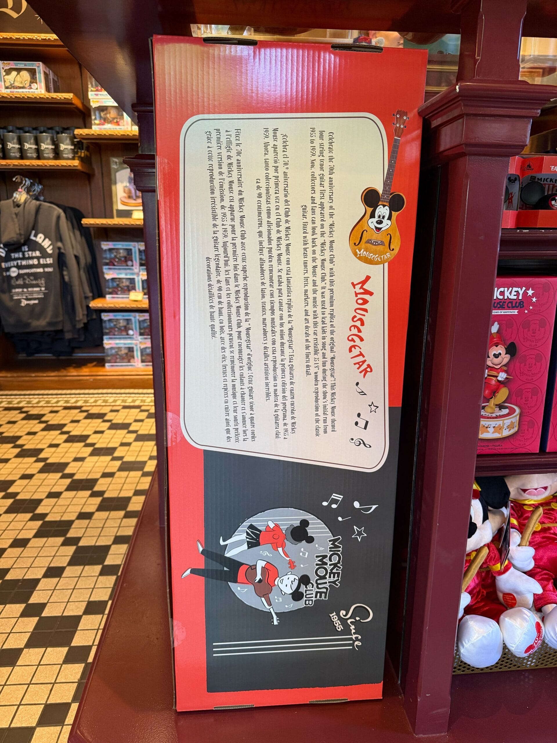 Red and black Mickey Mouse box featuring 70th Anniversary Disneyland art and dancing Mickey and Minnie on a store shelf.