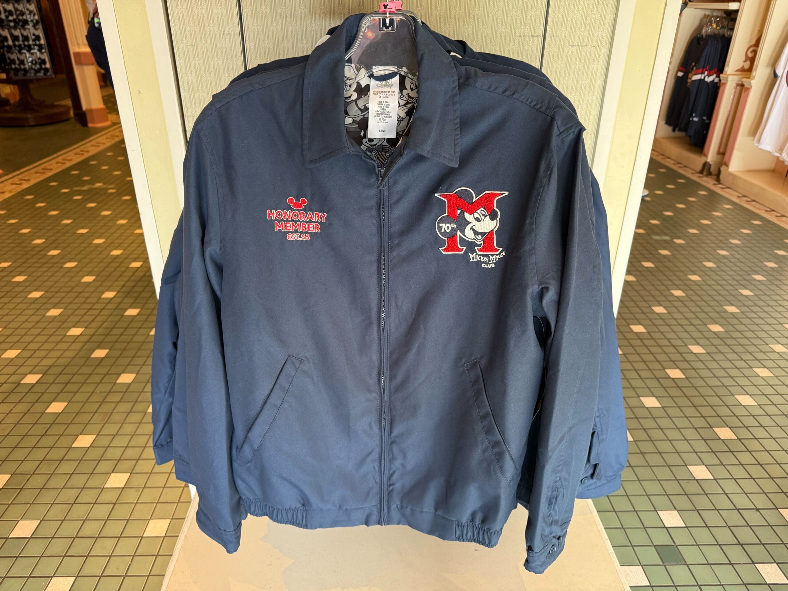 Navy jacket featuring “Honorary Member” and a smiling Mickey Mouse logo—celebrating 70th anniversary Disneyland merchandise.