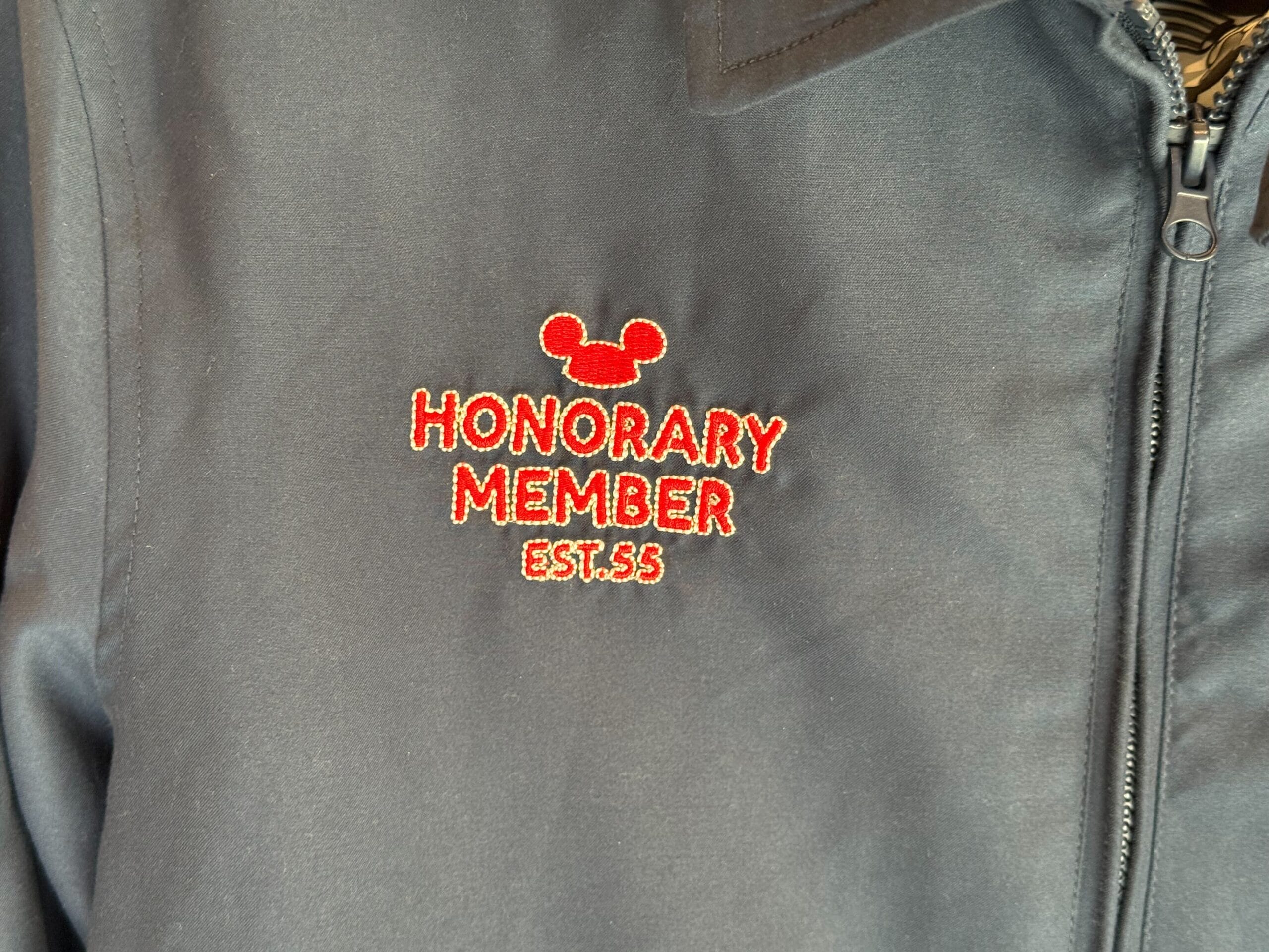 Gray jacket with red "Honorary Member EST. 55" text and a Mickey Mouse head—classic Mickey Mouse Club merchandise.