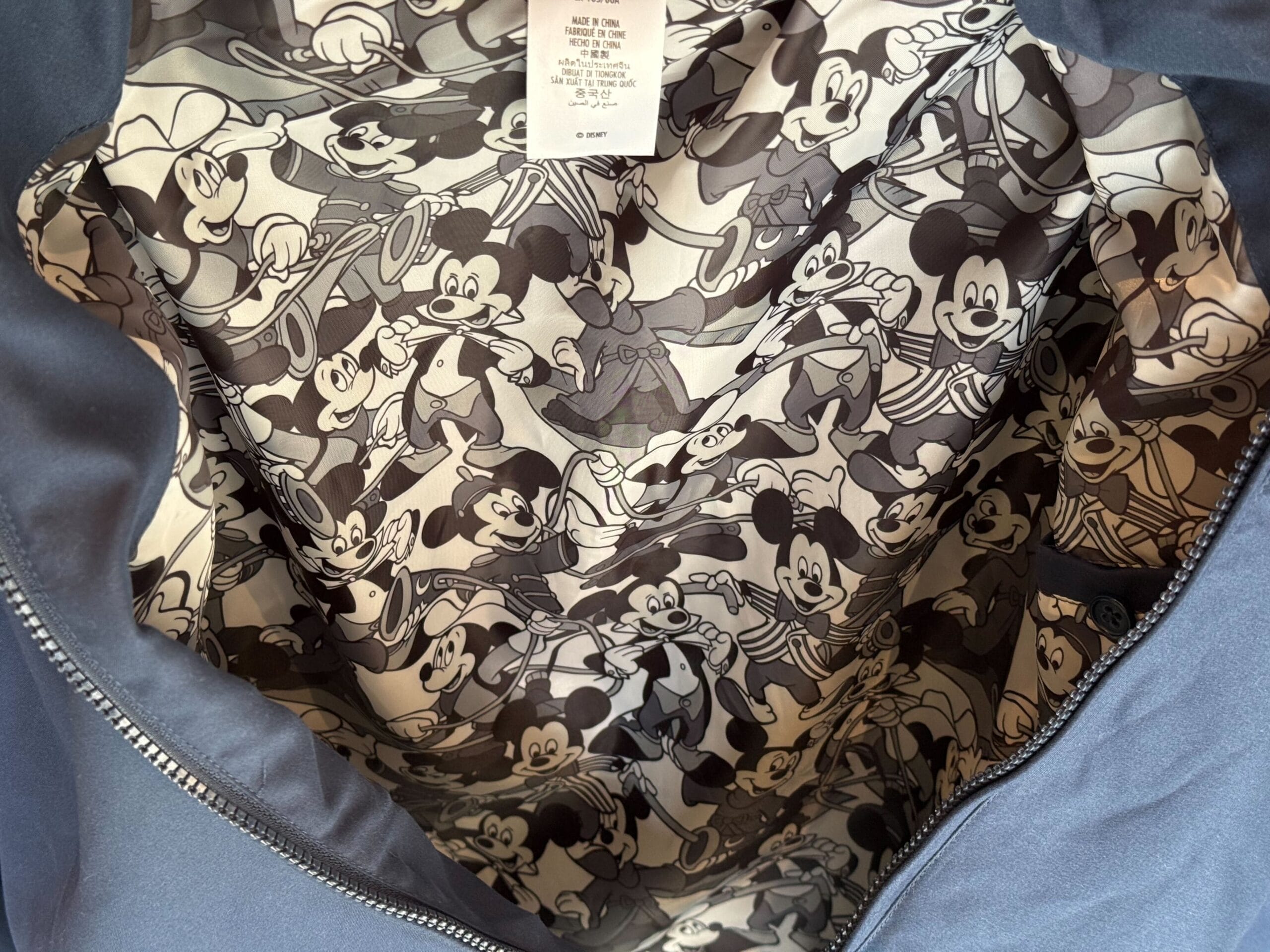 Jacket lining featuring a black and white pattern inspired by Mickey Mouse Club merchandise classics.
