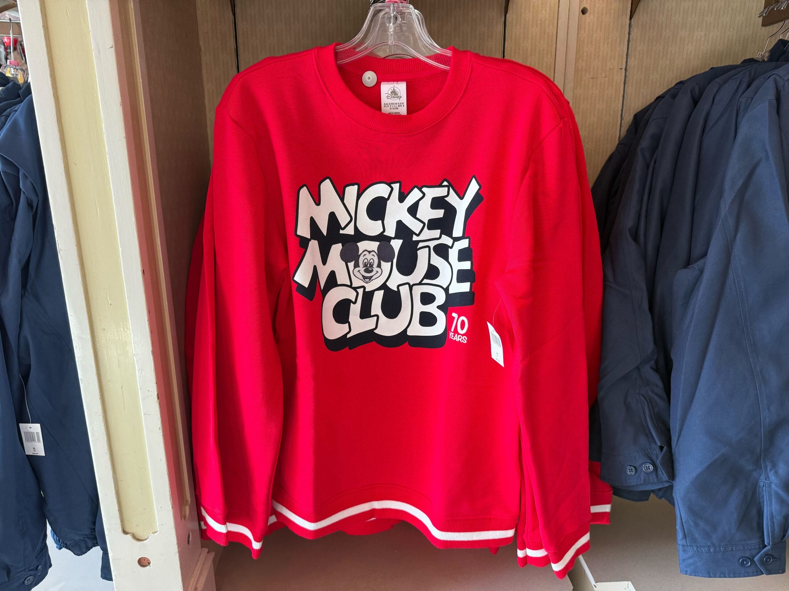Red Mickey Mouse Club sweatshirt with bold logo, part of the 70th Anniversary Disneyland Merchandise collection.
