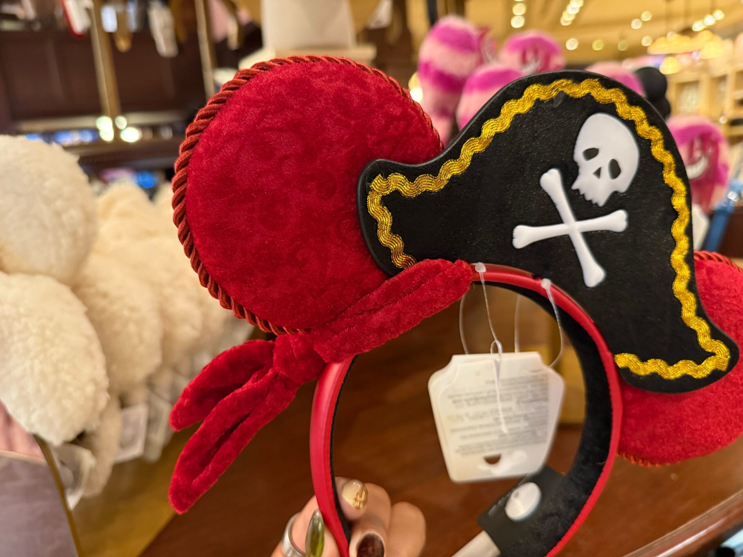 A headband with red Minnie Mouse ears and a black pirate hat, inspired by Pirates of the Caribbean at Disneyland.