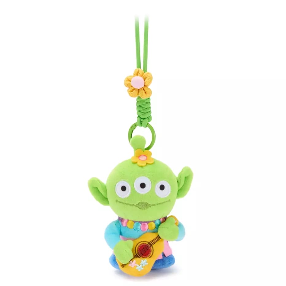 Plush green alien with three eyes, holding a guitar, and colorful accessories—Toy Story bag charms from Disney Store China.