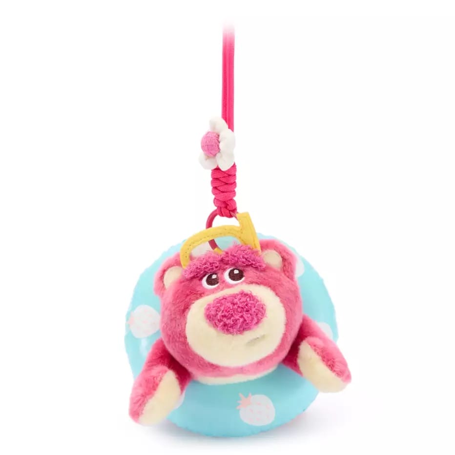 Plush pink bear with a crown, hanging on a pink string, in a blue float—Disney Store China Toy Story bag charm.