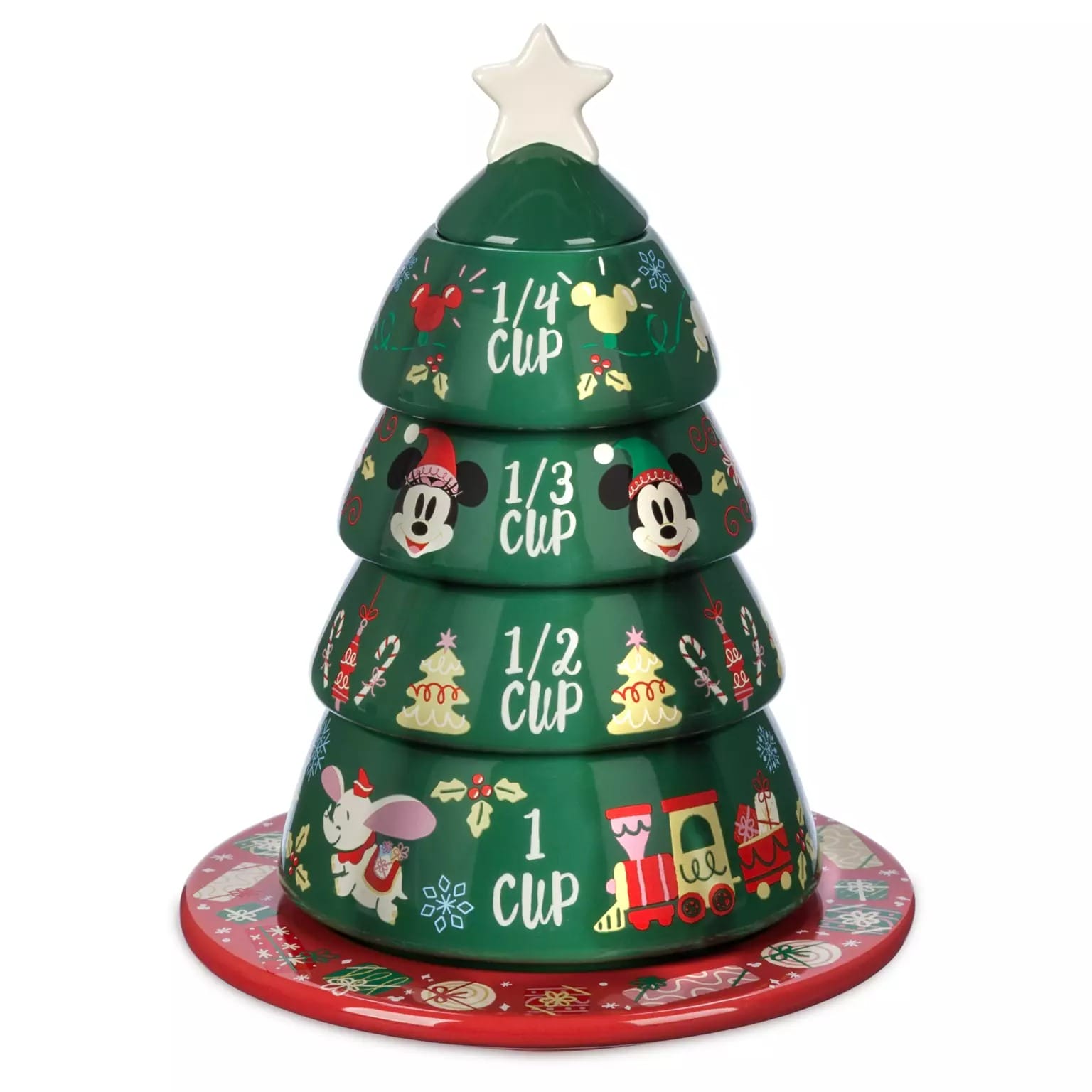 Four stacking measuring cups shaped like a Christmas tree, part of 2025 Disney Christmas merchandise, on a festive red plate.