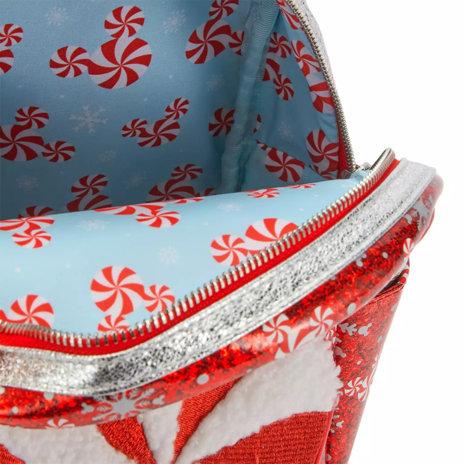 Open bag showing blue lining with peppermint candy patterns, silver zipper, red glittery exterior—Disney Store exclusive.