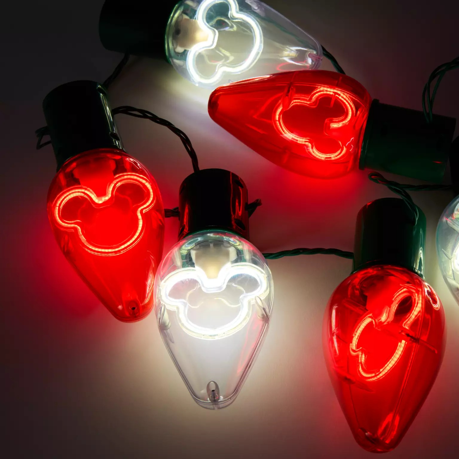 Red and white bulb lights with glowing Mickey Mouse outlines—festive Disney Christmas merchandise from the Disney Store 2025.