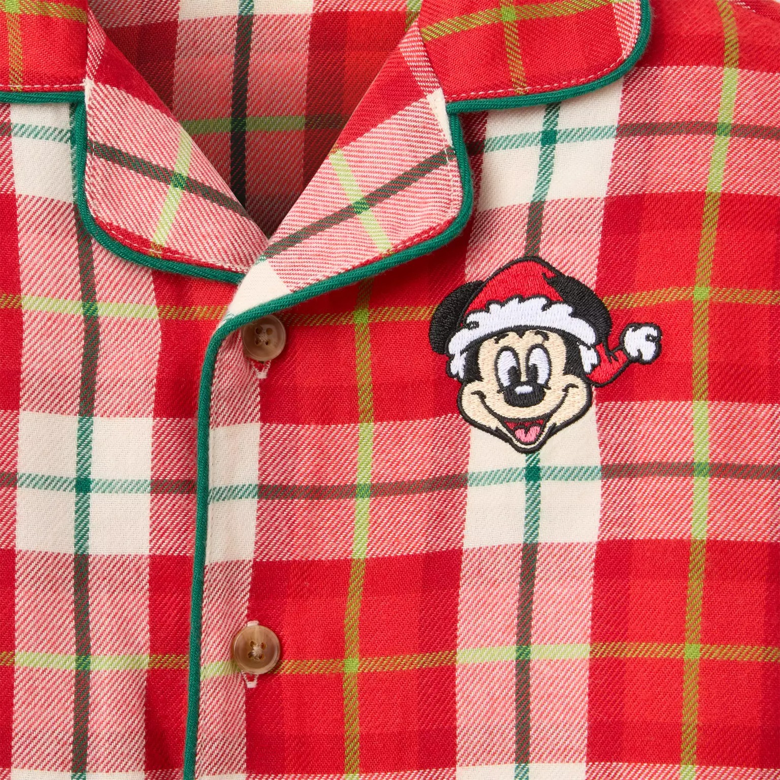 Red plaid pajama top with green trim, part of the 2025 Disney Christmas Merchandise at the Disney Store.