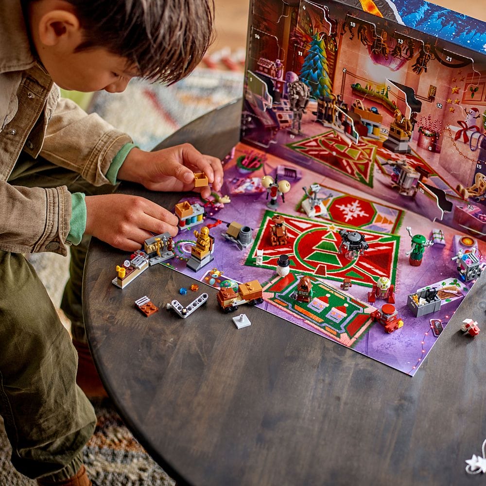 Child playing with a Disney LEGO Advent Calendar, perfect for Holiday 2025, on a round wooden table.
