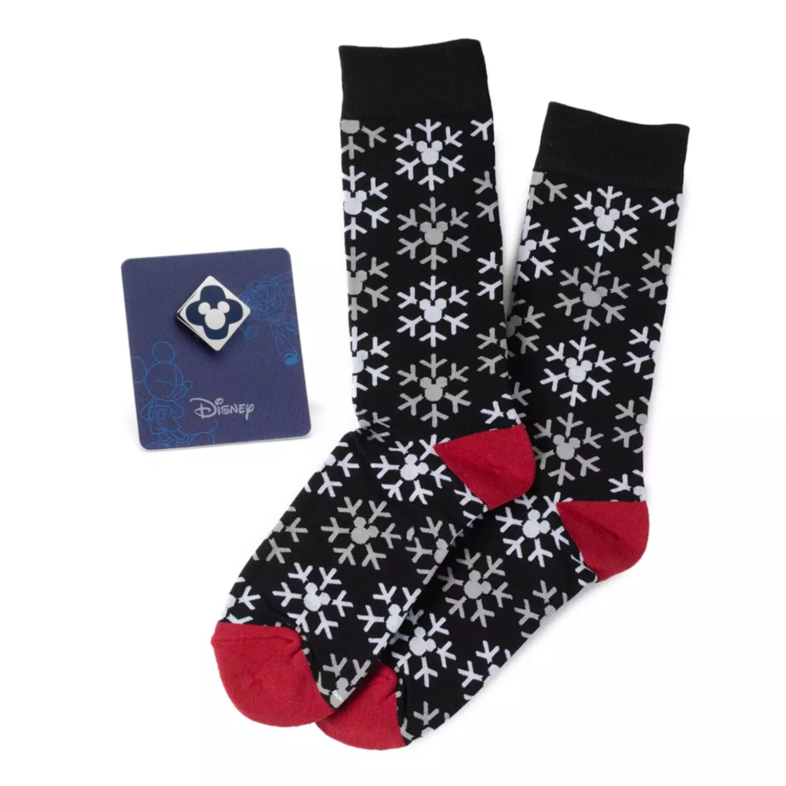 Black socks with red toes, snowflakes, plus a blue Disney Store Mickey ears pin—festive holiday Disney Parks merchandise.