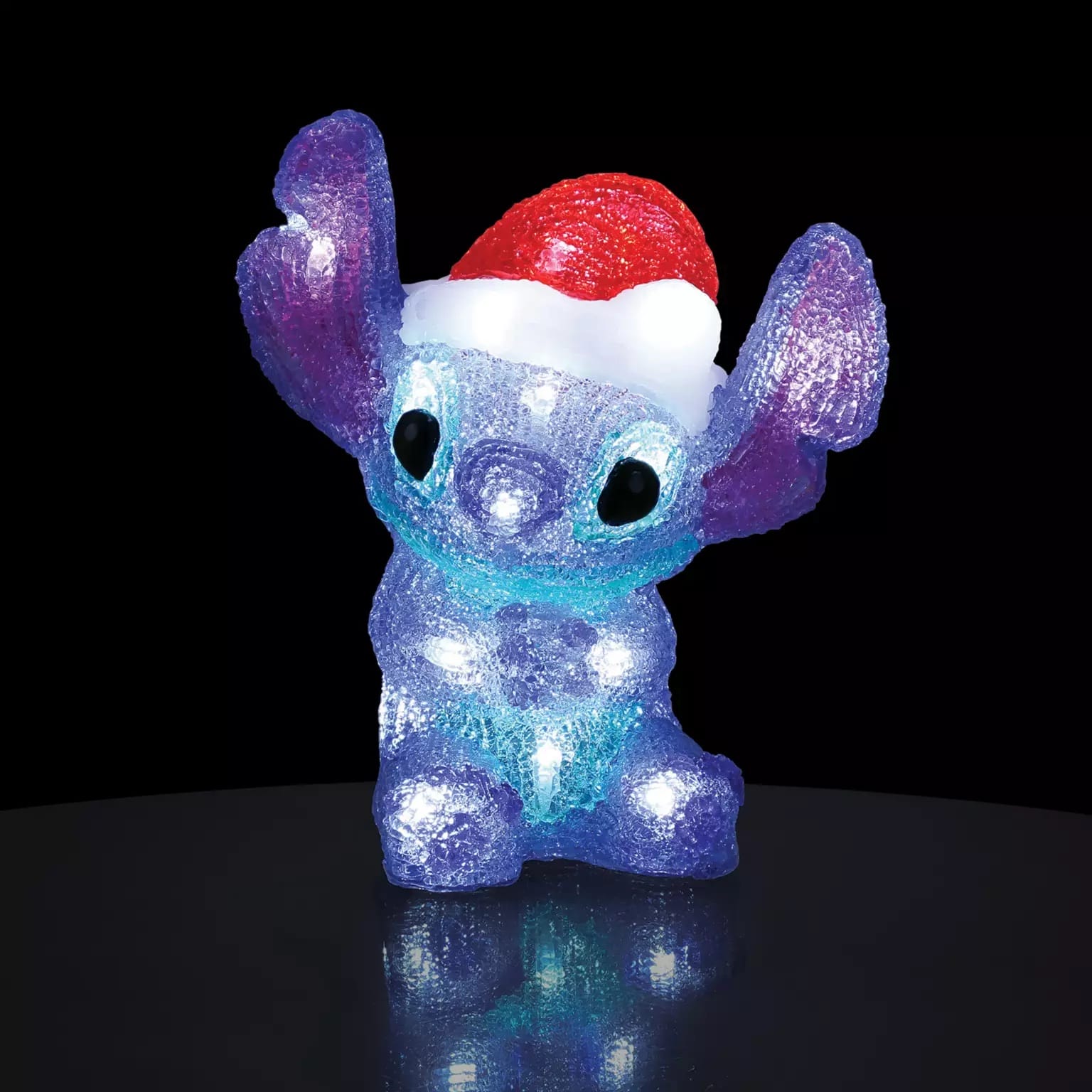 A glittery blue and purple Stitch in a Santa hat from Disney Parks 2025 Christmas line—perfect alongside any Disney castle display.
