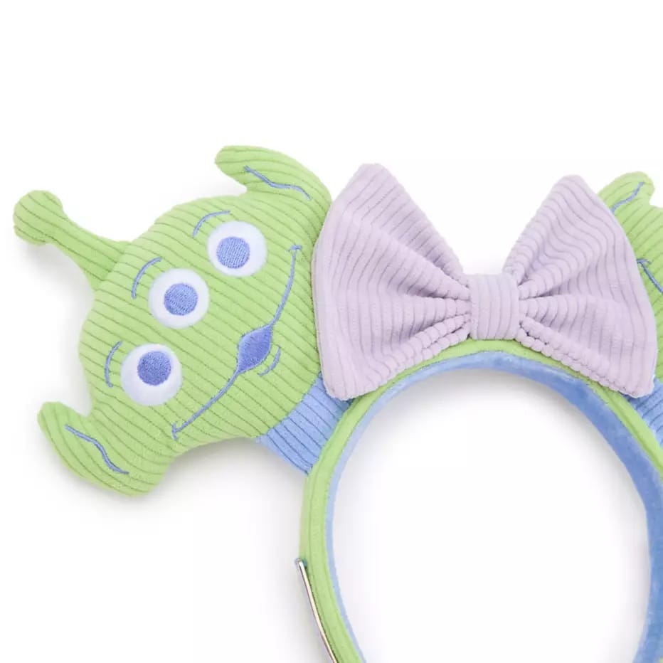 Headband with a green three-eyed alien and a lavender bow, pairs well with your Toy Story backpack or Alien ear headband.