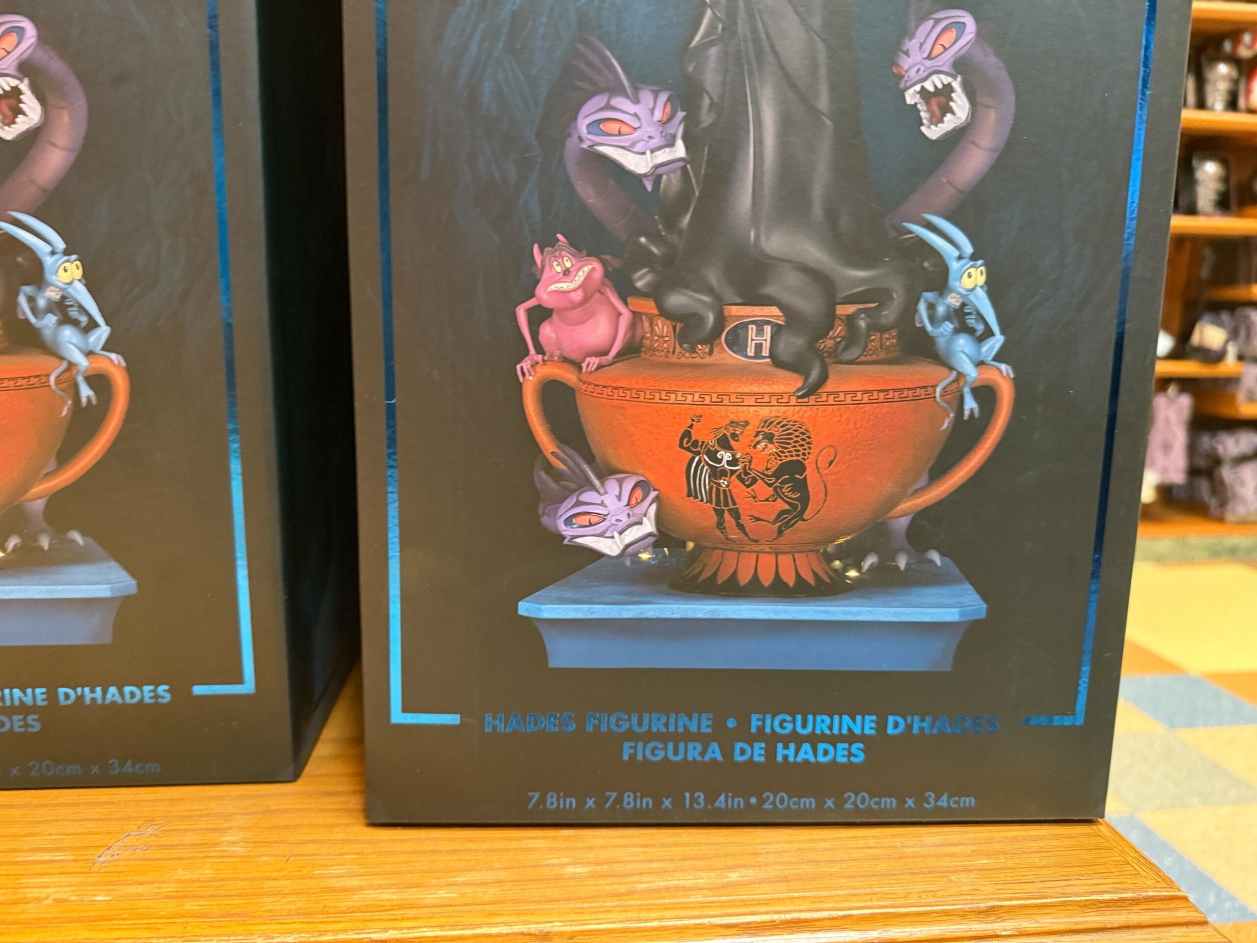 Box displaying a Hades Figure with cartoonish creatures and a red vase, perfect for Disney Villains or California Adventure fans.