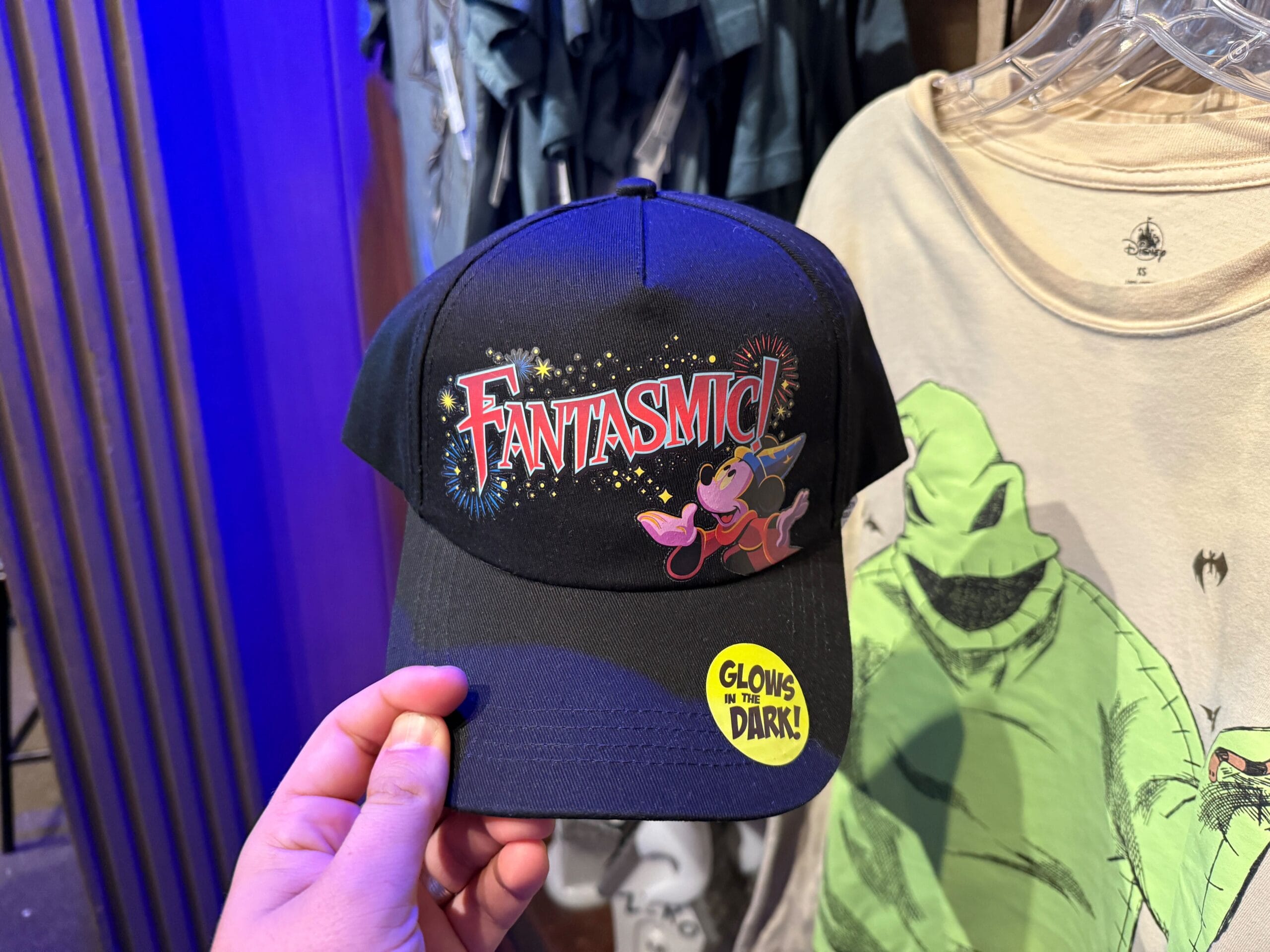 A black Fantasmic Baseball Cap with Mickey Mouse, fireworks, and a “glow-in-the-dark” sticker.