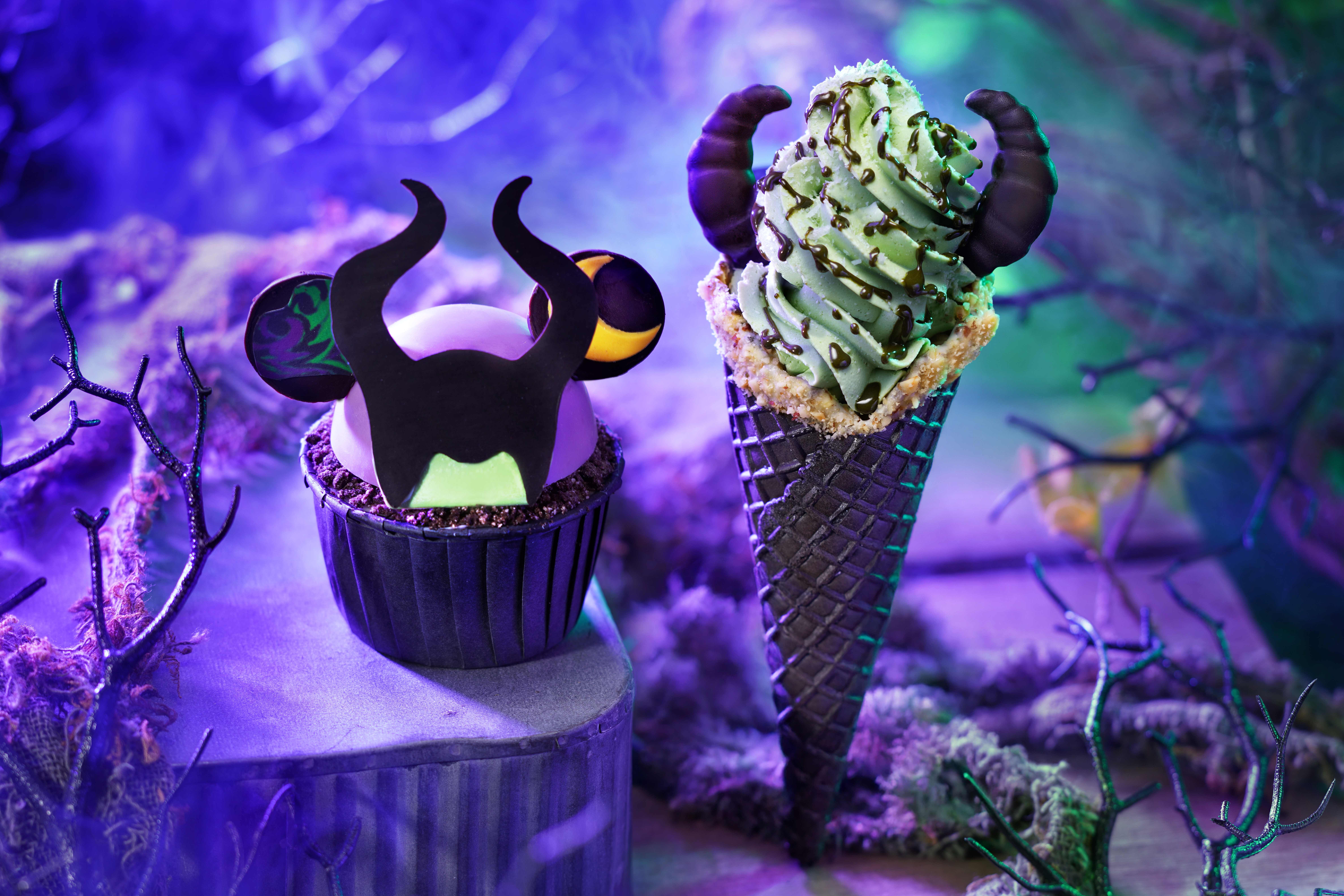 A cupcake and ice cream cone with black horns and green frosting, inspired by Disney Villains for Halloween.