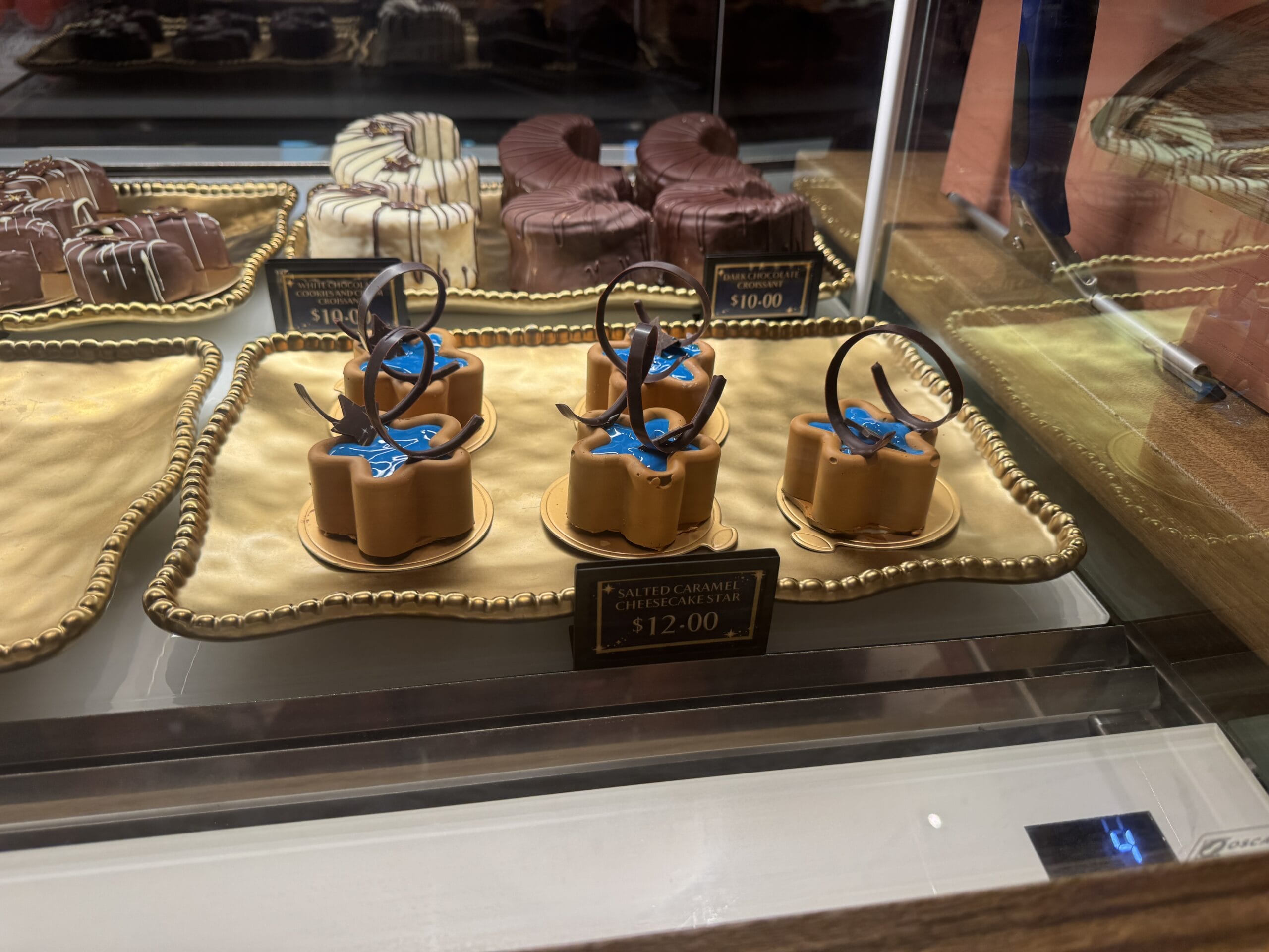 Salted caramel cheesecake star desserts with blue decor—an Epic Universe treat for a rainy day, just $12 each.