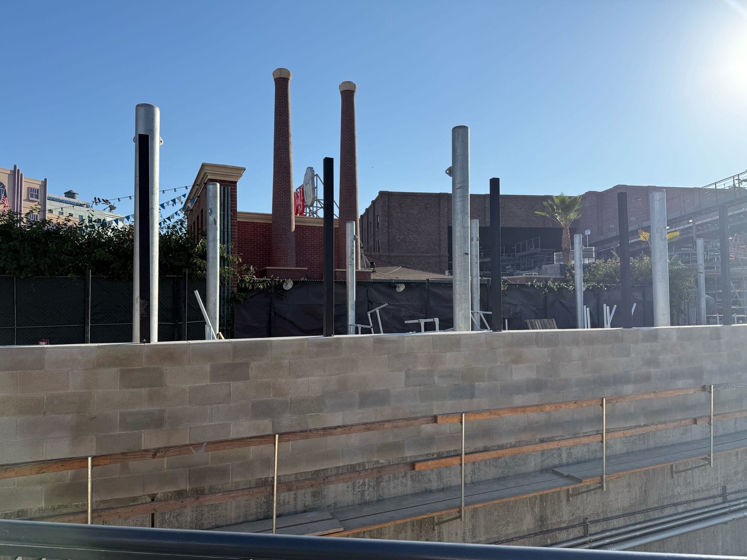 A brick facade and structural pylons sit amid construction on the Fast & Furious: Hollywood Drift roller coaster at Universal Studios Hollywood.