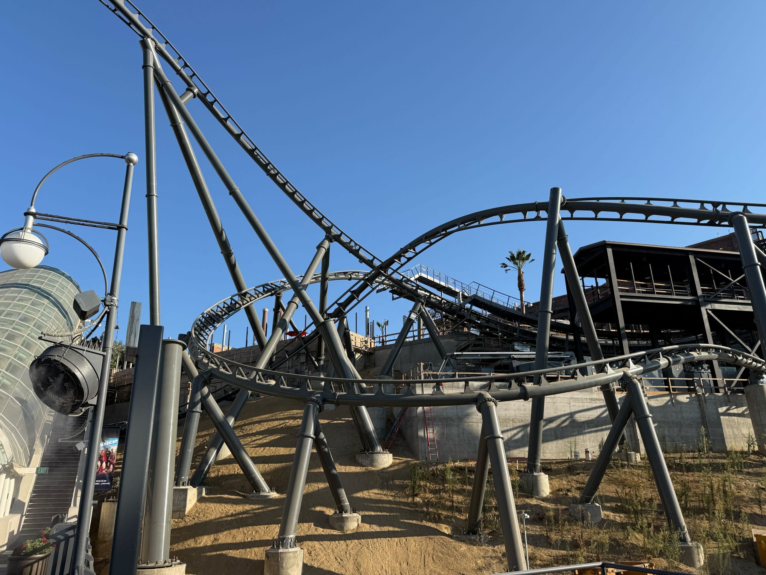 The Fast & Furious: Hollywood Drift roller coaster track on the hill next to the glass escalator canopy on the Upper Lot at Universal Studios Hollywood.